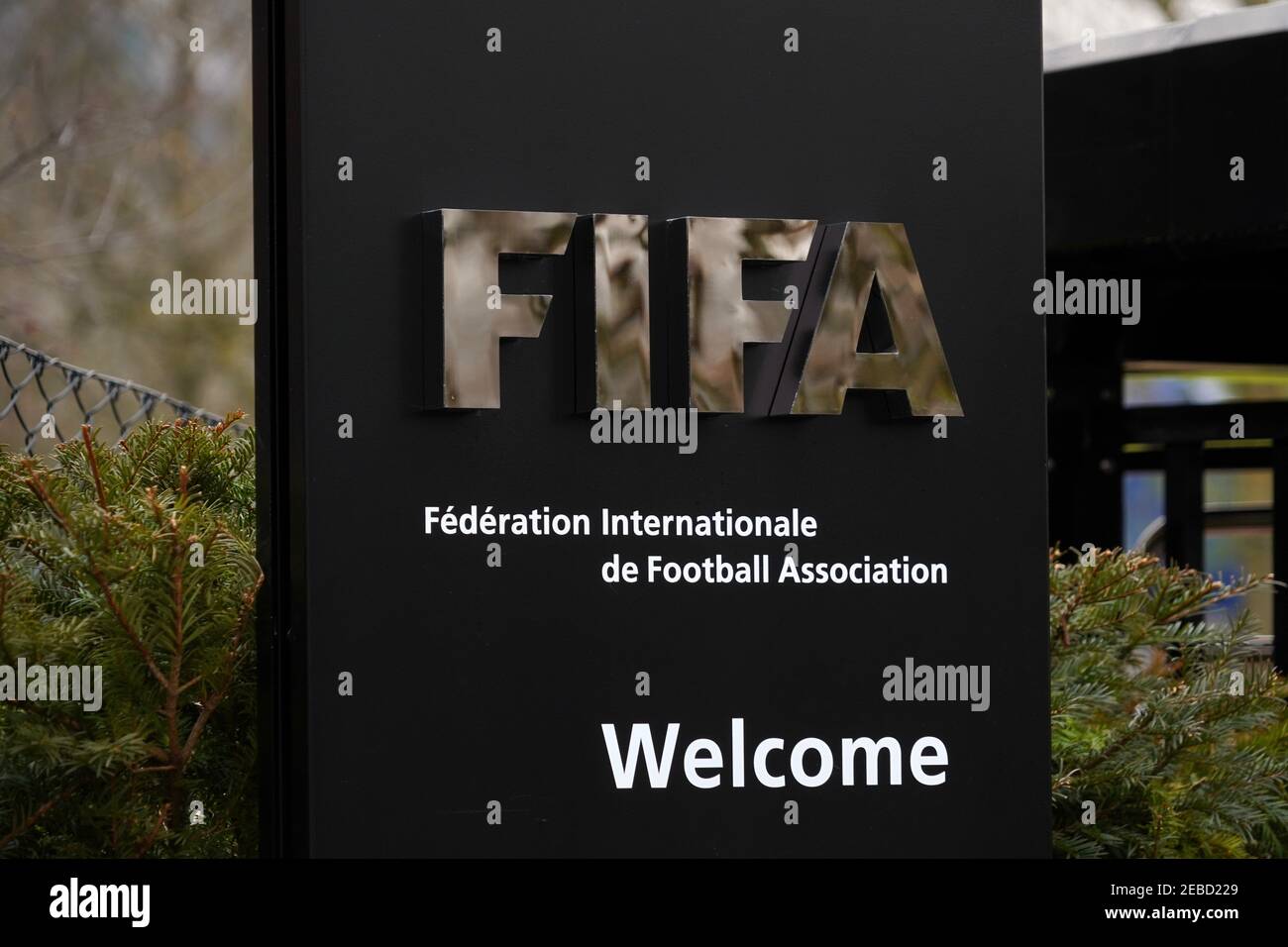 FIFA signpost at the entry for visitors, welcoming them to the headquarters in Zurich. There is a full name of the association in French. Stock Photo