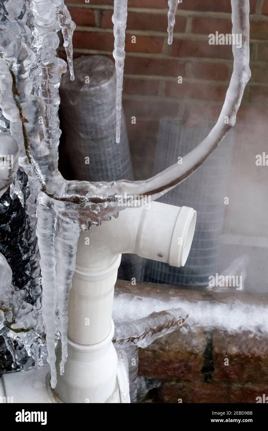 Central heating boiler flue emitting steam on freezing winter day, United Kingdom. Stock Photo