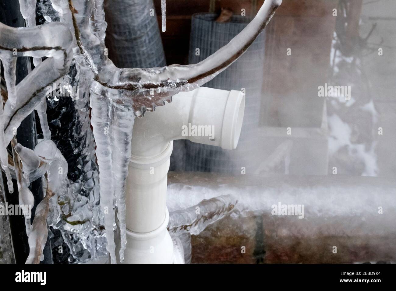 Central heating boiler flue emitting steam on freezing winter day, United Kingdom. Stock Photo