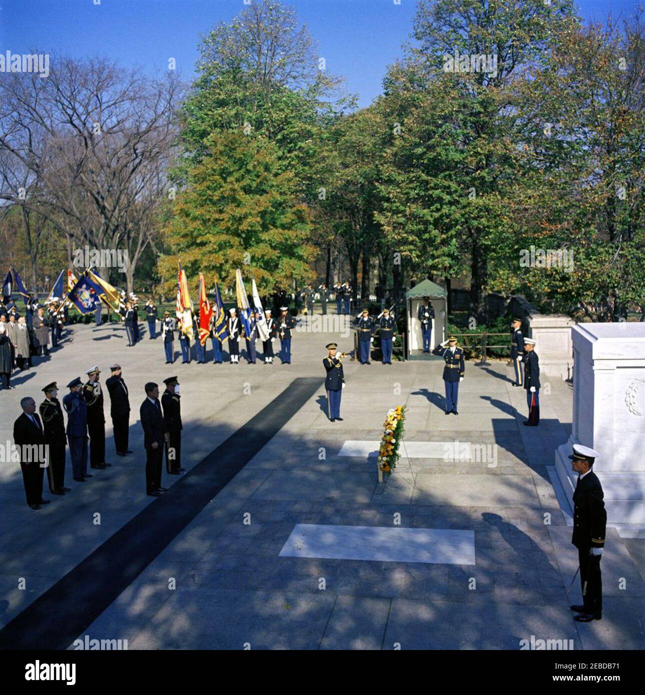 Address at Veterans Day Ceremonies, Arlington National Cemetery, 11:01AM. President John F. Kennedy attends a wreath laying ceremony at the Tomb of the Unknown Soldier as part of Veterans Day remembrances. President Kennedy stands with Major General Paul A. Gavan, Commanding General of the Military District of Washington. Standing behind the President (L-R): John S. Gleason, Administrator of Veterans Affairs; Military Aide to the President General Chester V. Clifton; Air Force Aide to the President Colonel Godfrey T. McHugh; Naval Aide to the President Captain Tazewell T. Shepard; and Thomas S Stock Photo