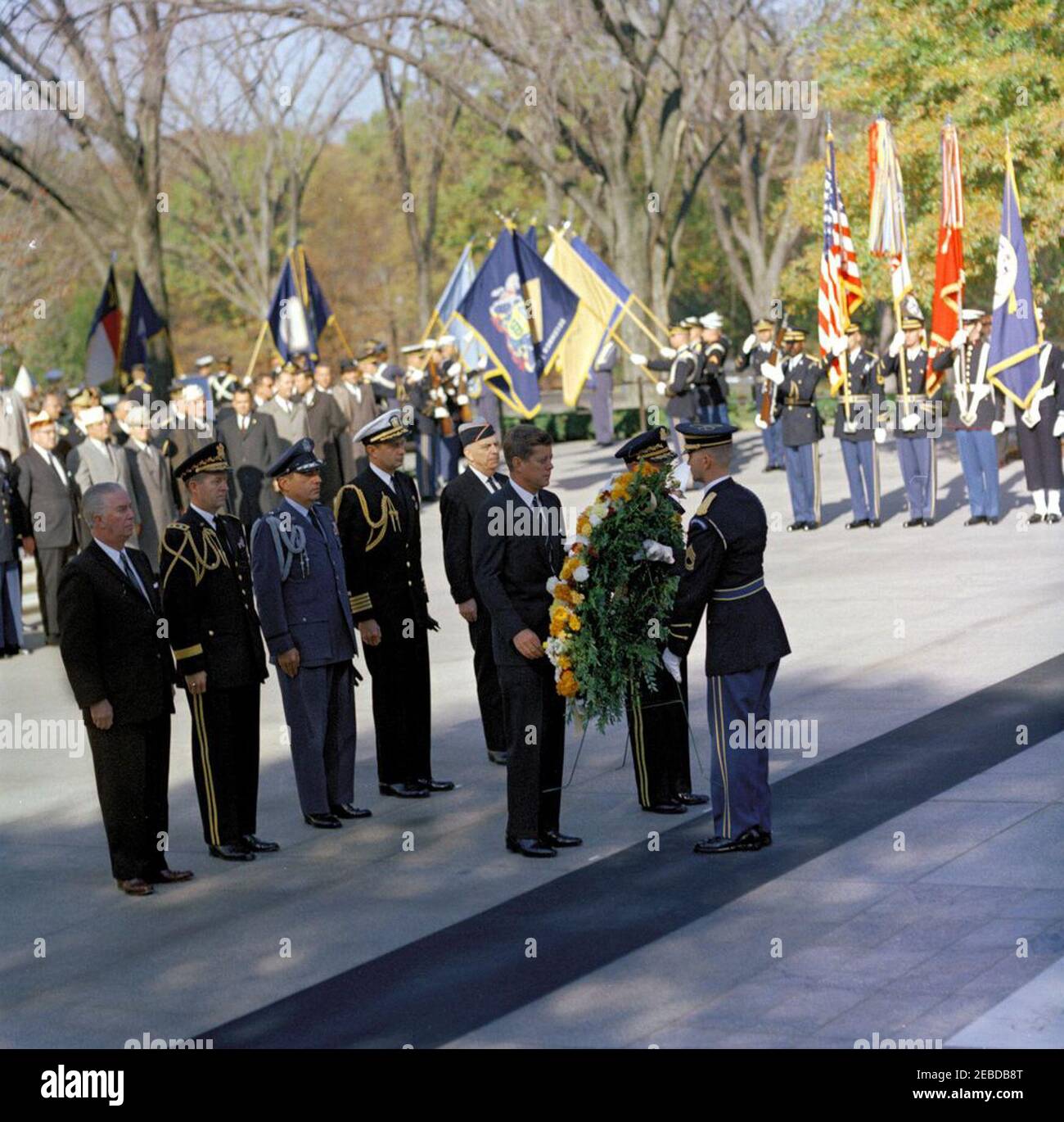 Address at Veterans Day Ceremonies, Arlington National Cemetery, 11:01AM. President John F. Kennedy participates in a wreath laying ceremony at the Tomb of the Unknown Soldier as part of Veterans Day remembrances. President Kennedy stands with Major General Paul A. Gavan, Commanding General of the Military District of Washington. Standing behind the President (L-R): John S. Gleason, Administrator of Veterans Affairs; Military Aide to the President General Chester V. Clifton; Air Force Aide to the President Colonel Godfrey T. McHugh; Naval Aide to the President Captain Tazewell T. Shepard; and Stock Photo