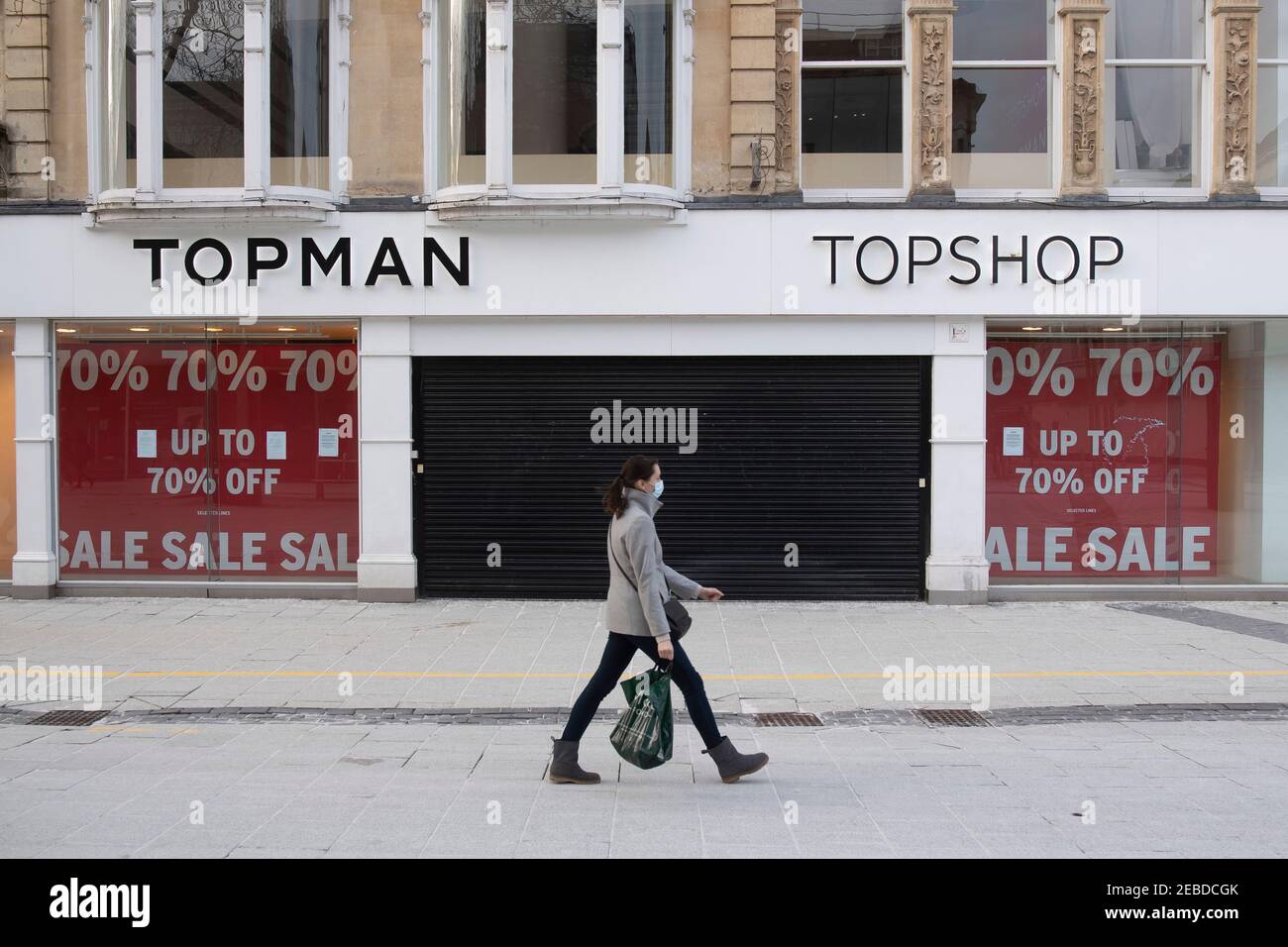 A woman walks past a closed Topman and Topshop store on Queen Street in  Cardiff, Wales, United Kingdom Stock Photo - Alamy