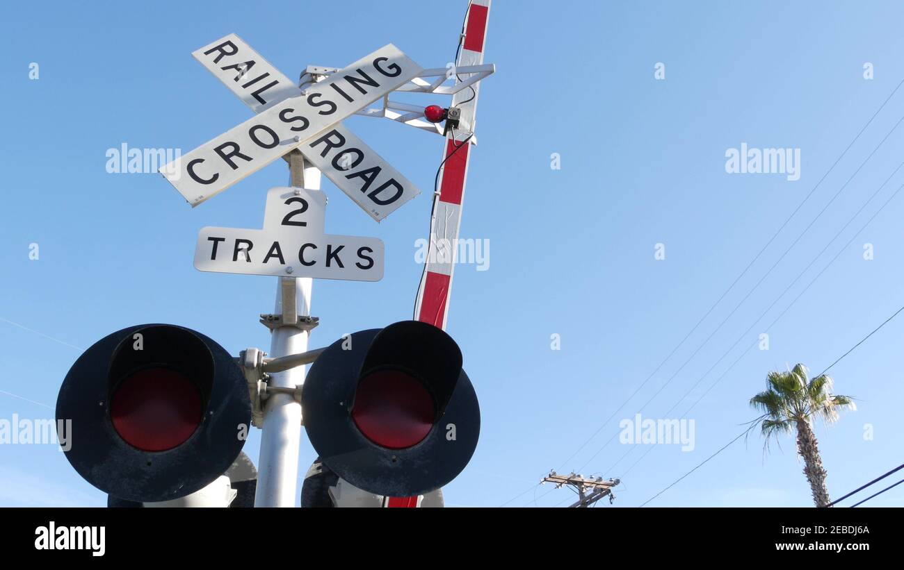 Level crossing warning signal in USA. Crossbuck notice and red traffic