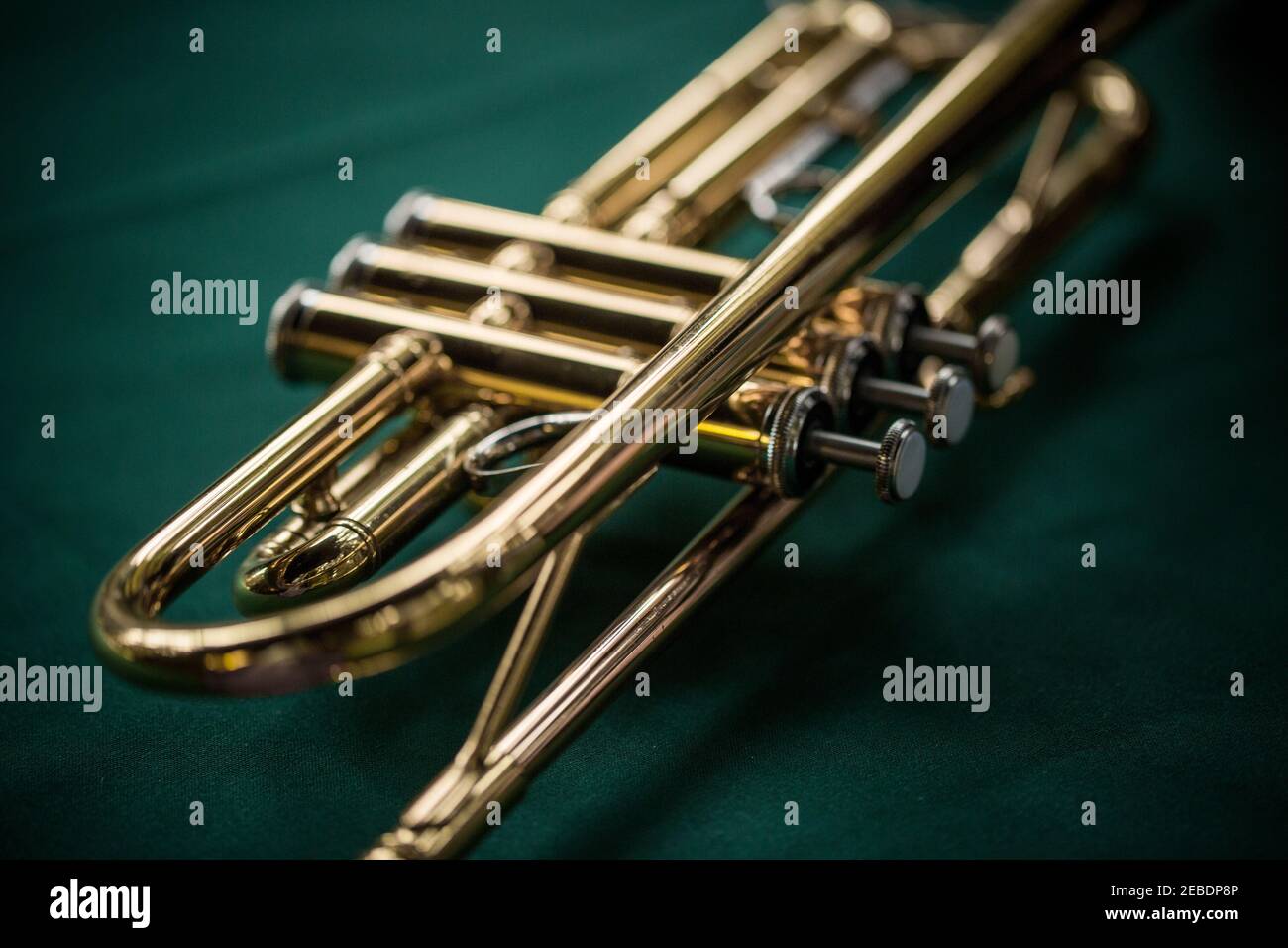 Close up macro still life of brass trumpet on green background Stock Photo