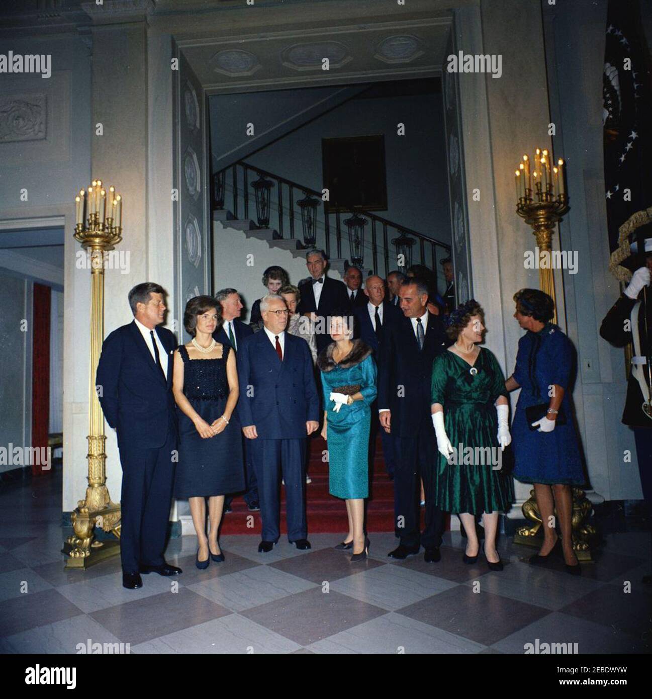 Judicial Reception, 6:00PM. White House reception for Judicial Branch. Front row (L u2013 R): President John F. Kennedy; First Lady Jacqueline Kennedy; Chief Justice Earl Warren; Lady Bird Johnson; Vice President Lyndon Johnson; Nina Warren, wife of Chief Justice Warren; Ethel Kennedy. Second row (L u2013 R): Supreme Court Associate Justice William O. Douglas; Mercedes Douglas, wife of Justice Douglas (partially hidden); Supreme Court Associate Justice Hugo Black. Other guests unidentified. Grand Staircase, Entrance Hall, White House, Washington, D.C. Stock Photo