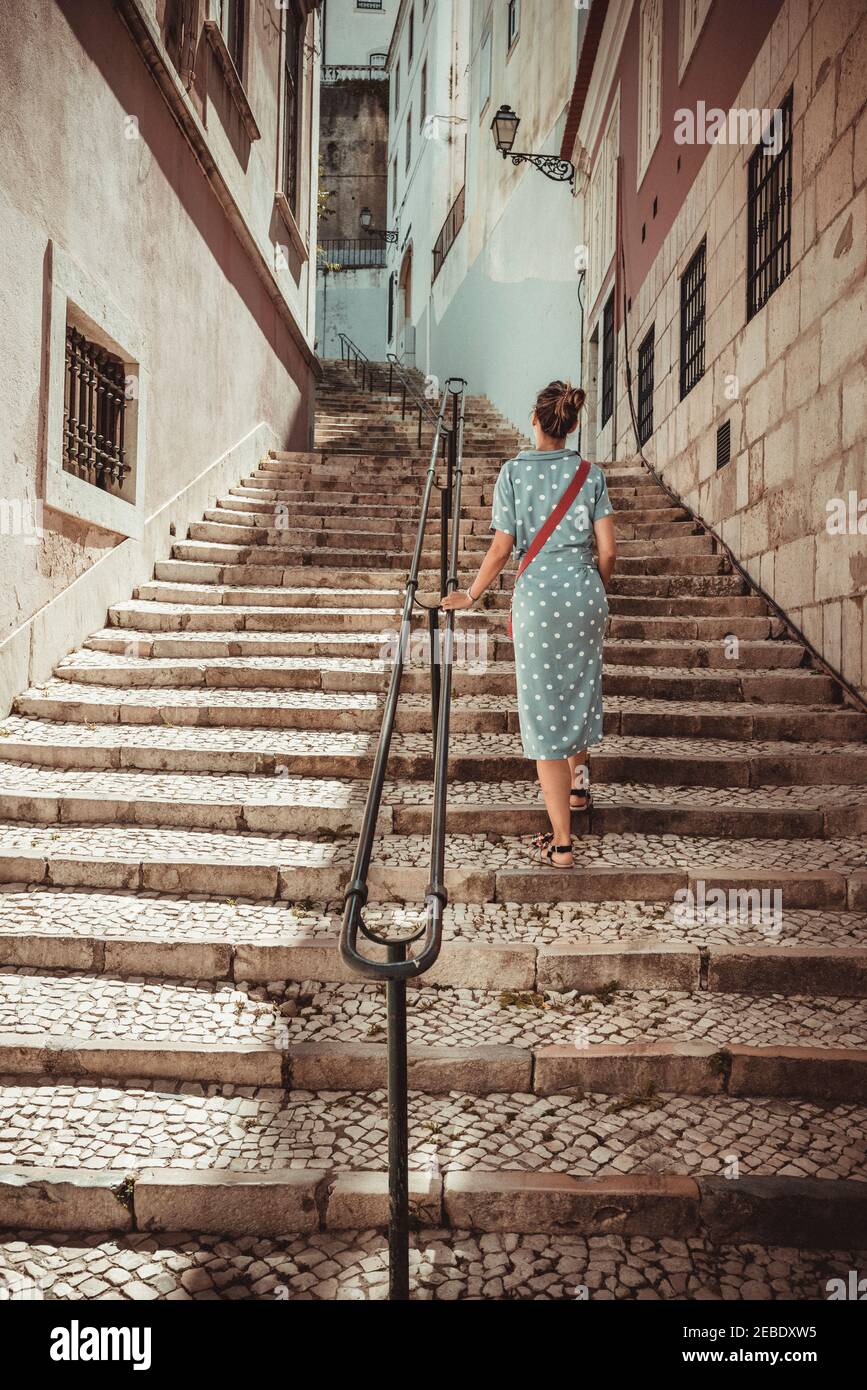 woman climbing stairs through the streets of Lisbon Stock Photo Alamy