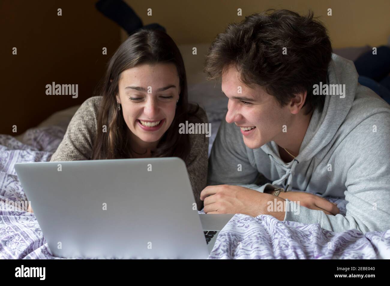 A caucasian male and female college student work on laptop together Stock Photo