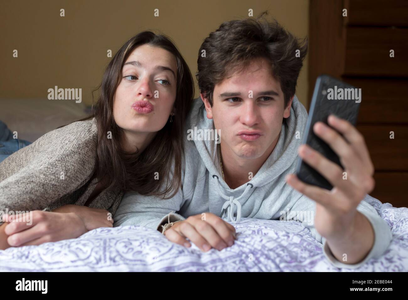 A caucasian male and female college student take selfies together Stock Photo