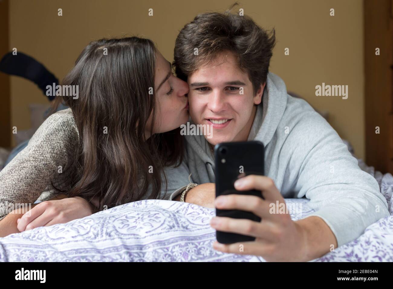 A caucasian male and female college student take selfies together Stock Photo