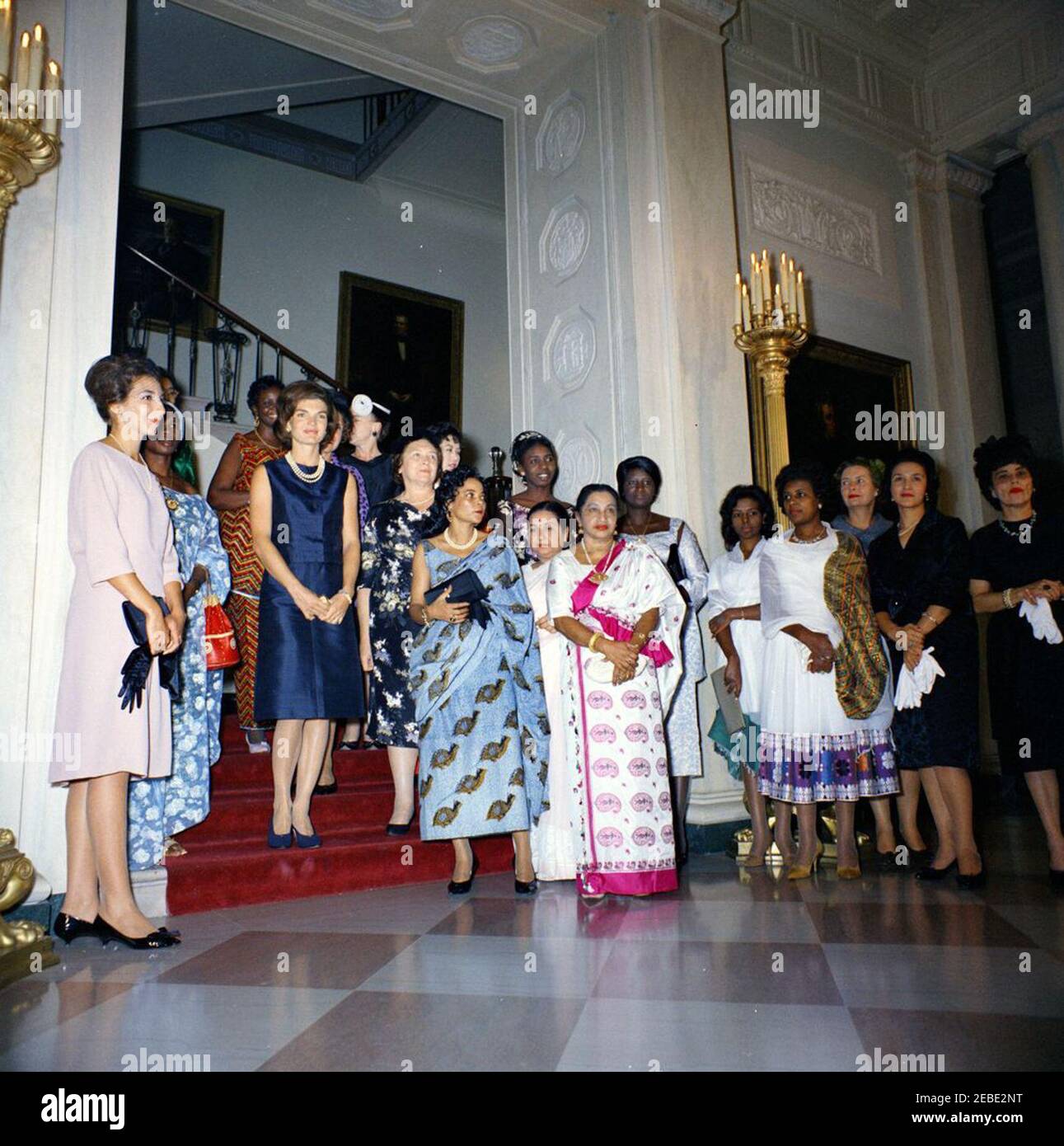 First Lady Jacqueline Kennedyu0027s (JBK) tea for wives of new ambassadors. First  Lady Jacqueline Kennedy hosts a tea party for wives of new ambassadors;  guests pose in front of the grand staircase