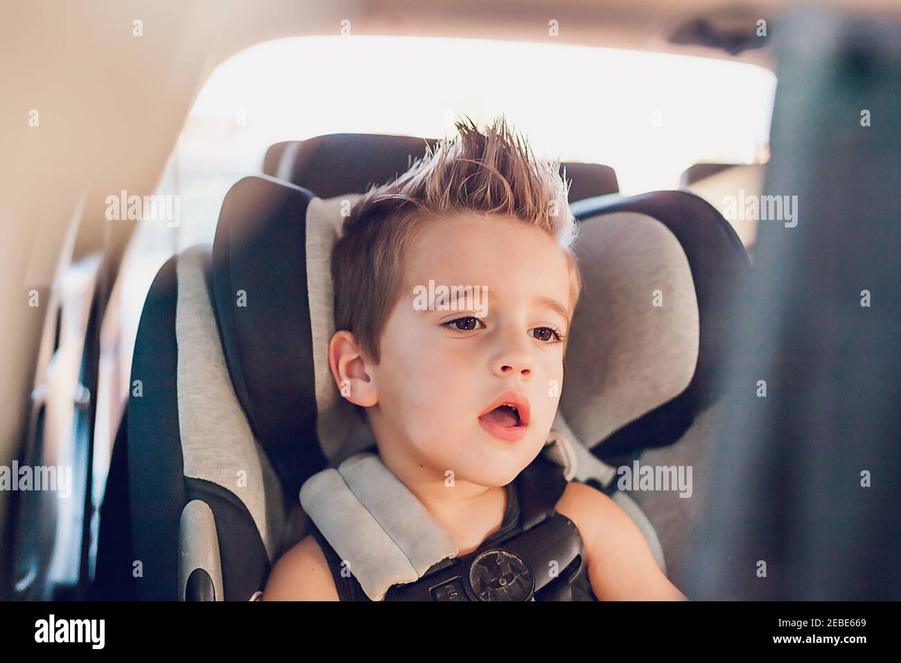 Preschool age boy sitting in car seat inside a car Stock Photo Alamy