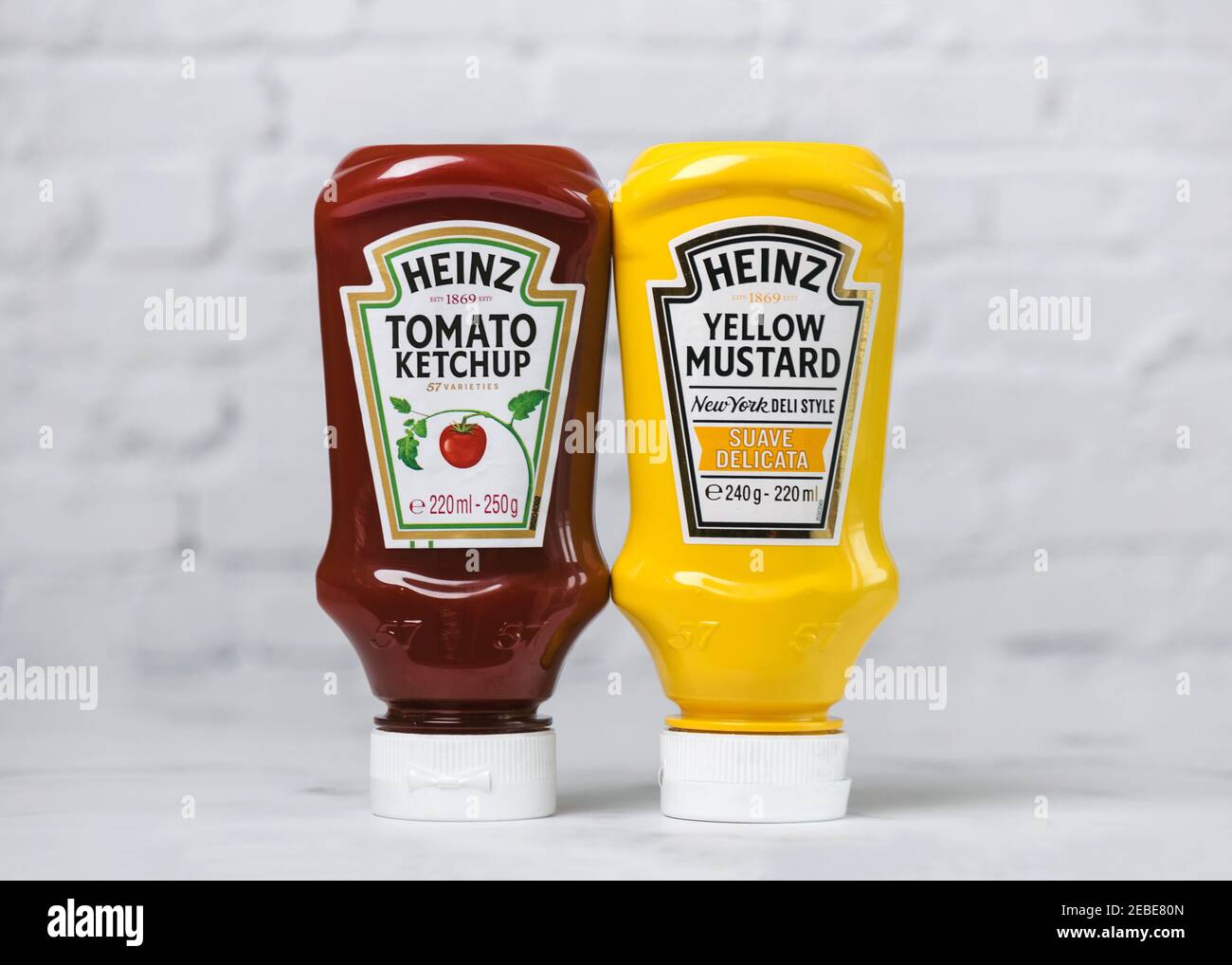 Heinz Ketchup bottle and bottle of Heinz Yellow Mustard on a white table Stock Photo