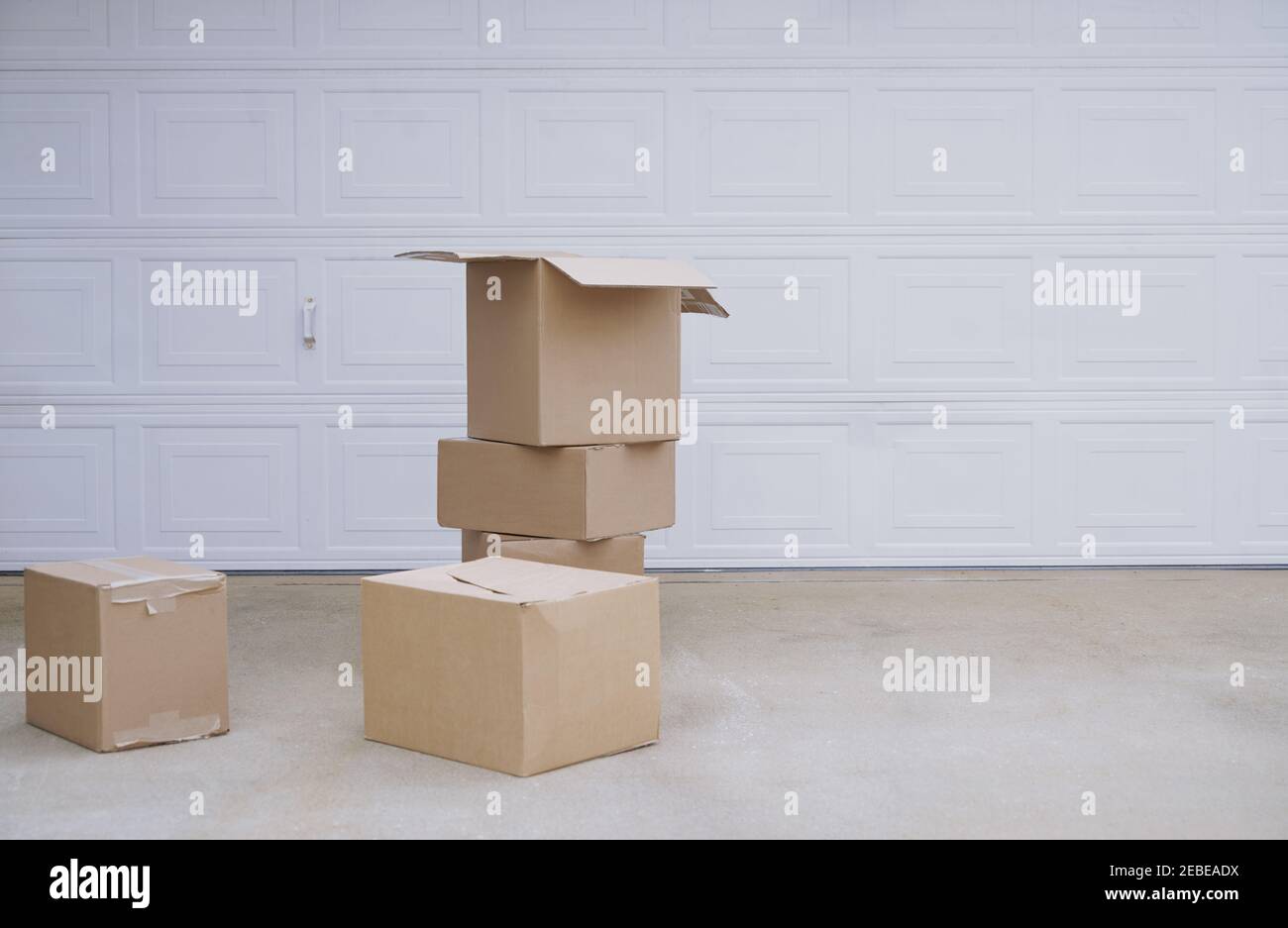 Cardboard boxes at the garage door Stock Photo Alamy
