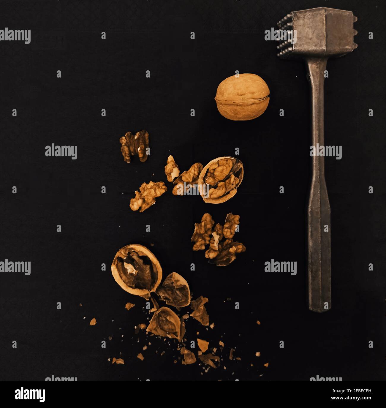 Cracked walnuts on black background Stock Photo