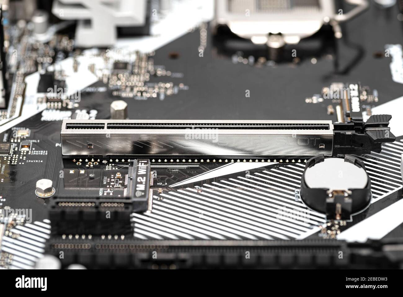 A macro shot of a PCI Express 3.0 x16 steel slot connector on a modern desktop motherboard. Stock Photo
