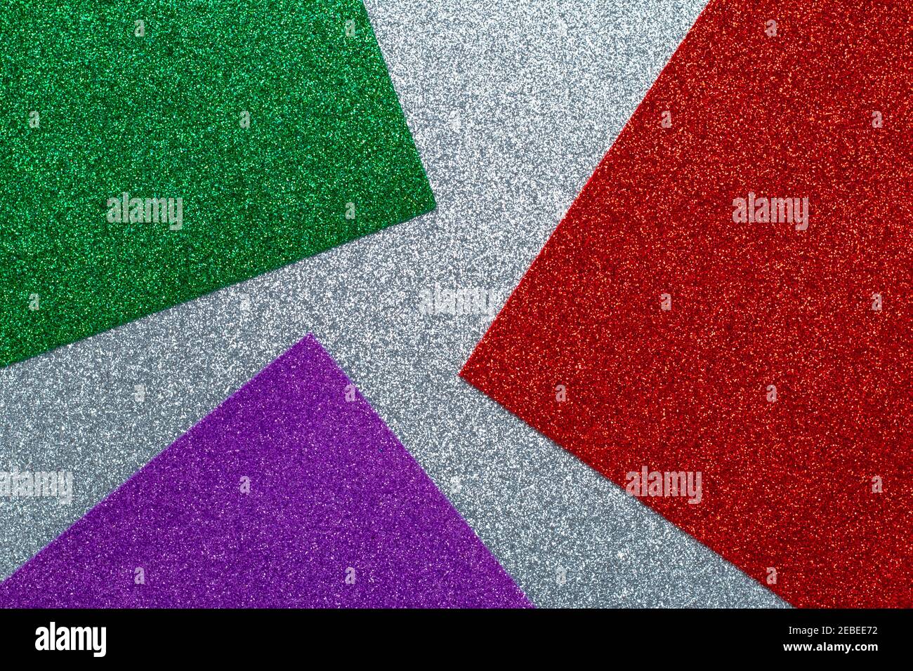 Glitter background, sparkle texture. Glossy surface, abstract shiny pattern. Gray, green, red and purple craft paper, sequin textile, fabric Stock Photo