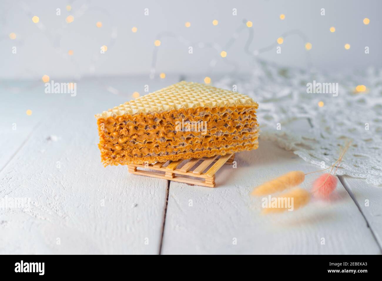 An appetizing piece of waffle cake with condensed milk. Close up view. Bakery food photography. Stock Photo