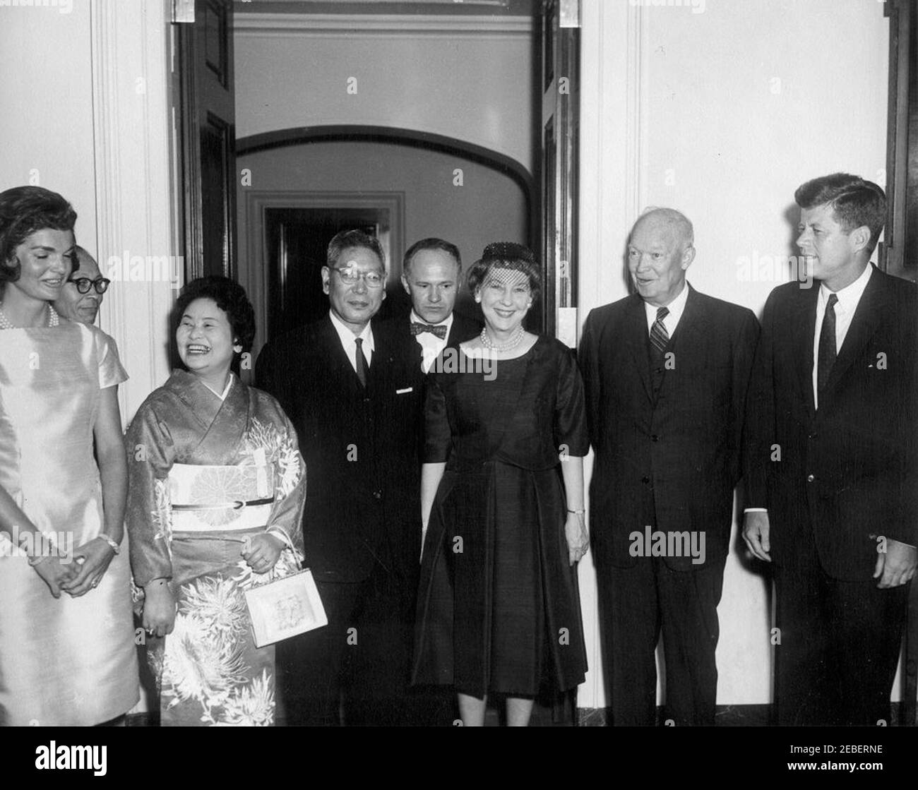 Luncheon in honor of Hayato Ikeda, Prime Minister of Japan, 1:00 PM. Luncheon in honor of Prime Minister of Japan Hayato Ikeda. (L-R) First Lady Jacqueline Kennedy, Counselor of the Ministry of Foreign Affairs Toshiro Shimanouchi, Mitsue Ikeda, Prime Minister of Japan Hayato Ikeda, interpreter James J. Wickel, former First Lady Mamie Doud Eisenhower, former President Dwight D. Eisenhower, and President John F. Kennedy. North Portico, White House, Washington, D.C. Stock Photo