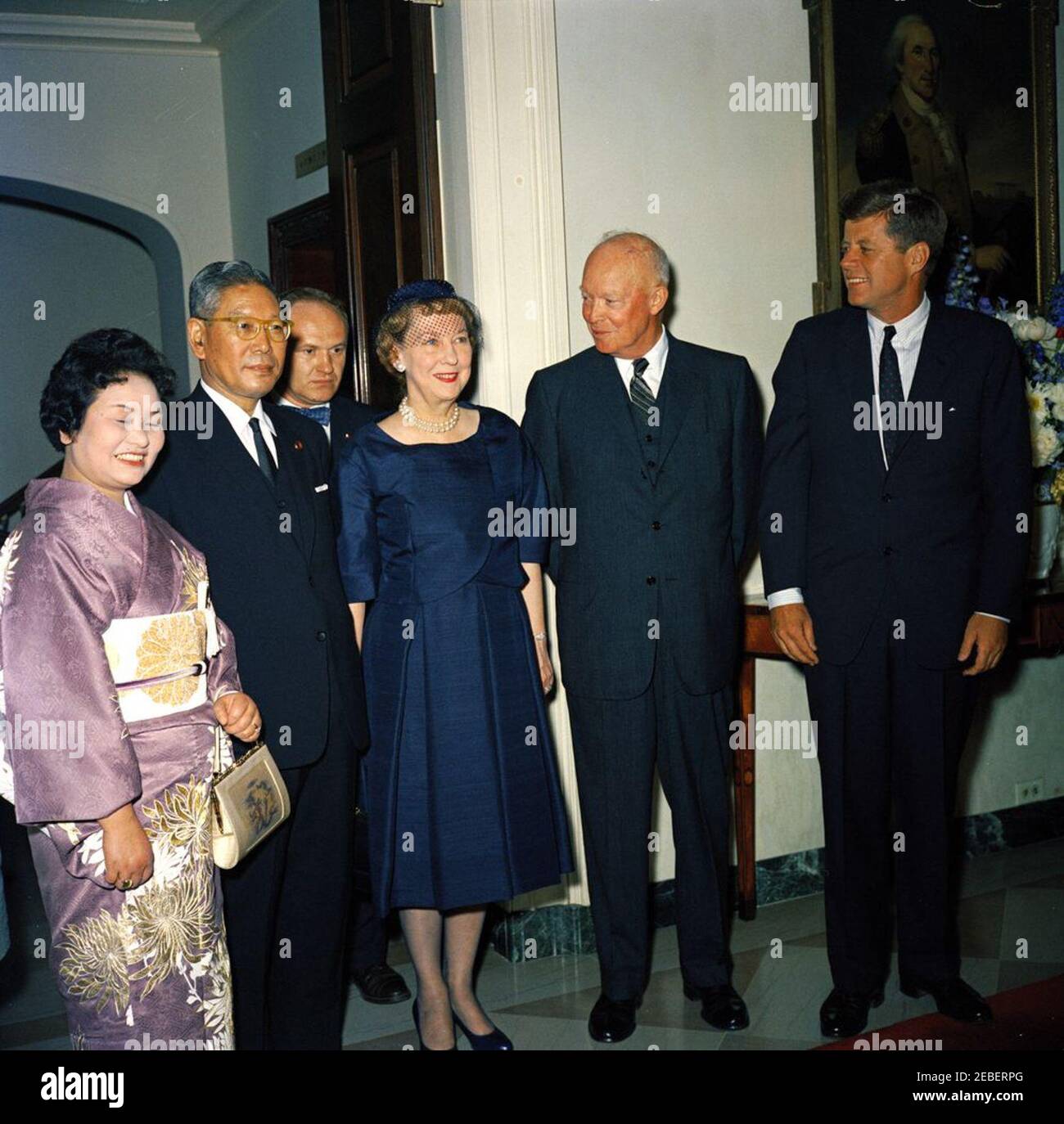 Luncheon in honor of Hayato Ikeda, Prime Minister of Japan, 1:00 PM. Luncheon in honor of Prime Minister of Japan Hayato Ikeda. (L-R) Mitsue Ikeda, Prime Minister of Japan Hayato Ikeda, interpreter James J. Wickel, former First Lady Mamie Doud Eisenhower, former President Dwight D. Eisenhower, and President John F. Kennedy. North Portico, White House, Washington, D.C. Stock Photo