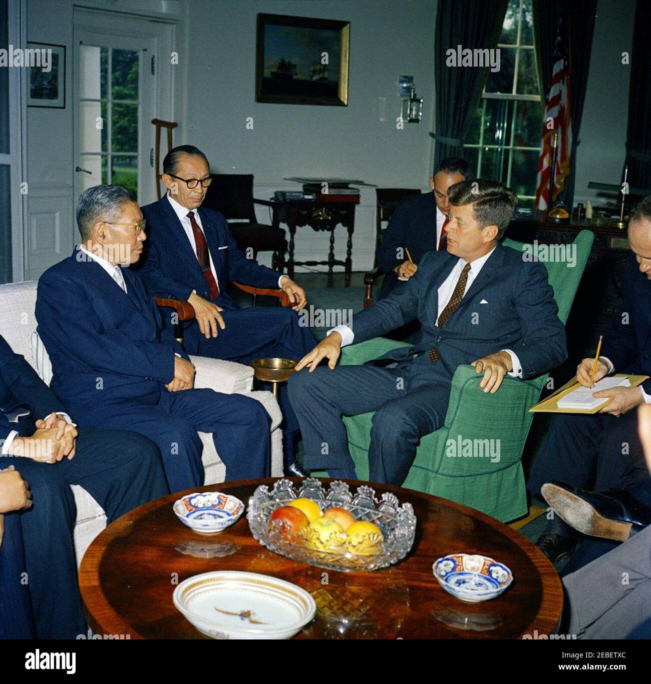 Meeting with Hayato Ikeda, the Prime Minister of Japan, 10:30AM. Meeting with the Prime Minister of Japan Hayato Ikeda. (L-R) Prime Minister Ikeda, Counselor of the Ministry of Foreign Affairs (Interpreter) Toshiro Shimanouchi, unidentified man, President John F. Kennedy, and interpreter James J. Wickel. Oval Office, White House, Washington, D.C. Stock Photo