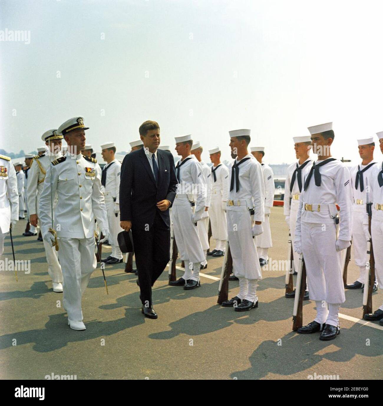 Commencement Address at the US Naval Academy, Annapolis, Maryland, 11:04AM. President John F. Kennedy en route to the commencement ceremony at the United States Naval Academy, Annapolis, Maryland. Also included in the photograph are Naval Aide to the President Tazewell T. Shepard and the United States Navy Honor Guard. Stock Photo