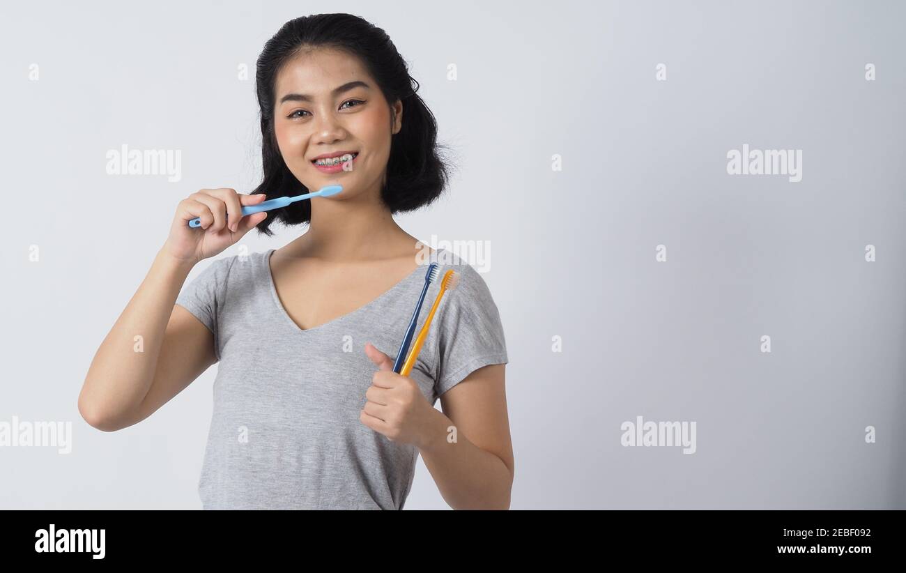 Dental brace teen girl smiling looking on a camera. white teeth with blue  braces. Dental care. Asian woman smile with orthodontic accessories.  Cosmeti Stock Photo - Alamy