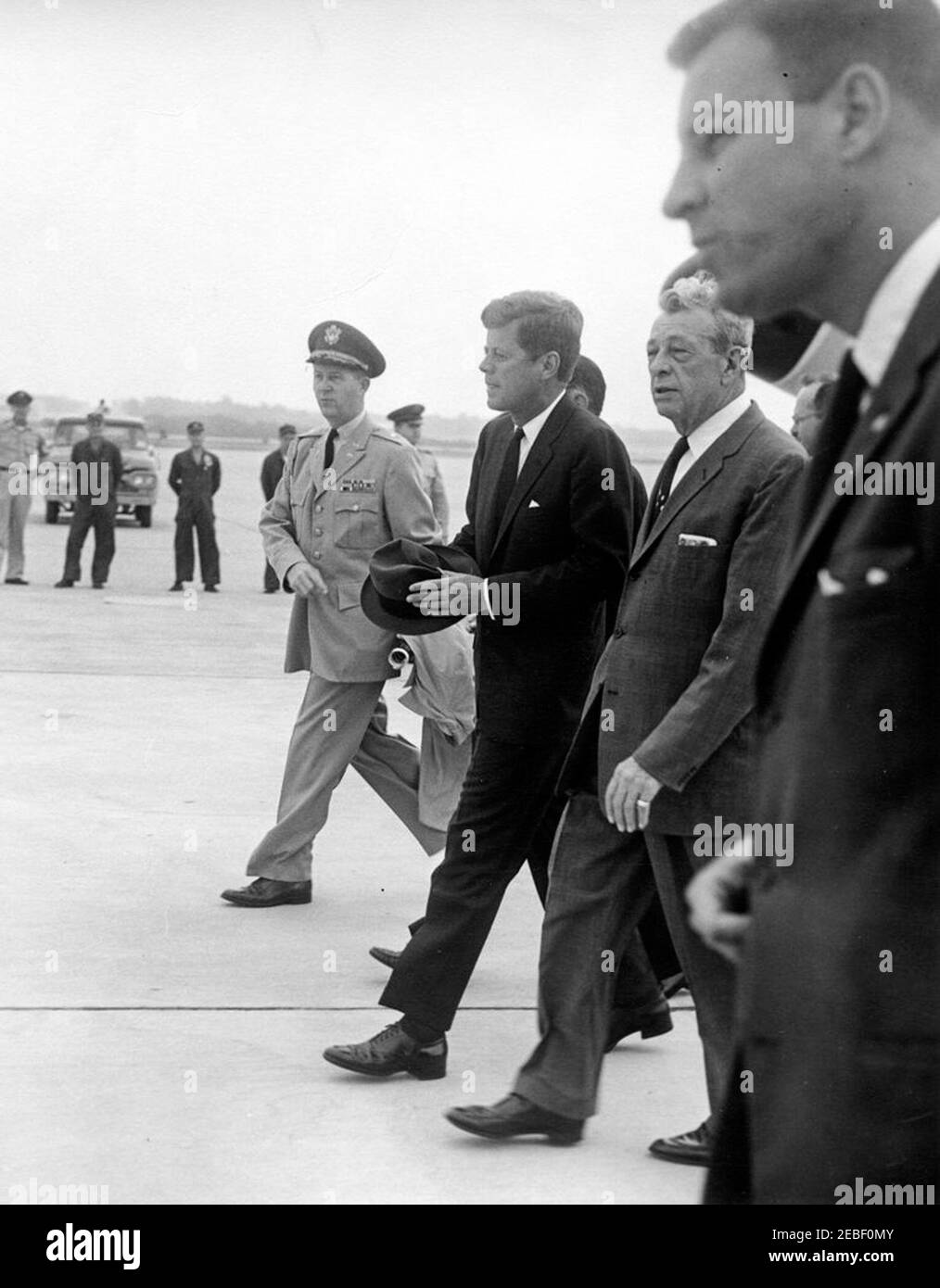 Arrival of President Kennedy at Andrews Air Force Base upon his return from Europe, 9:30AM. Arrival of President John F. Kennedy at Andrews Air Force Base in Maryland upon his return from Europe. (L-R) Military Aide to the President General Chester V. Clifton; President Kennedy (holding a hat); Senator Everett Dirksen (Illinois); White House Secret Service agent H. Stuart u0022Stuu0022 Knight. Stock Photo