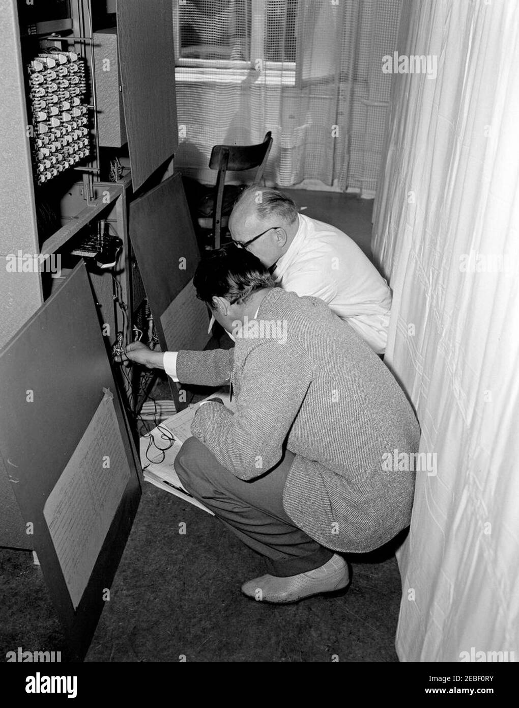 Trip to Europe: Arrival in Vienna, Austria 10:50AM; White House Army Signal Agency (WHASA) staff in Vienna. Two unidentified men work on White House Army Signal Agency (WHASA) equipment in preparation for a summit between President John F. Kennedy and Soviet Union Premier Nikita Khrushchev in Vienna, Austria. [Photograph by Harold Sellers] Stock Photo