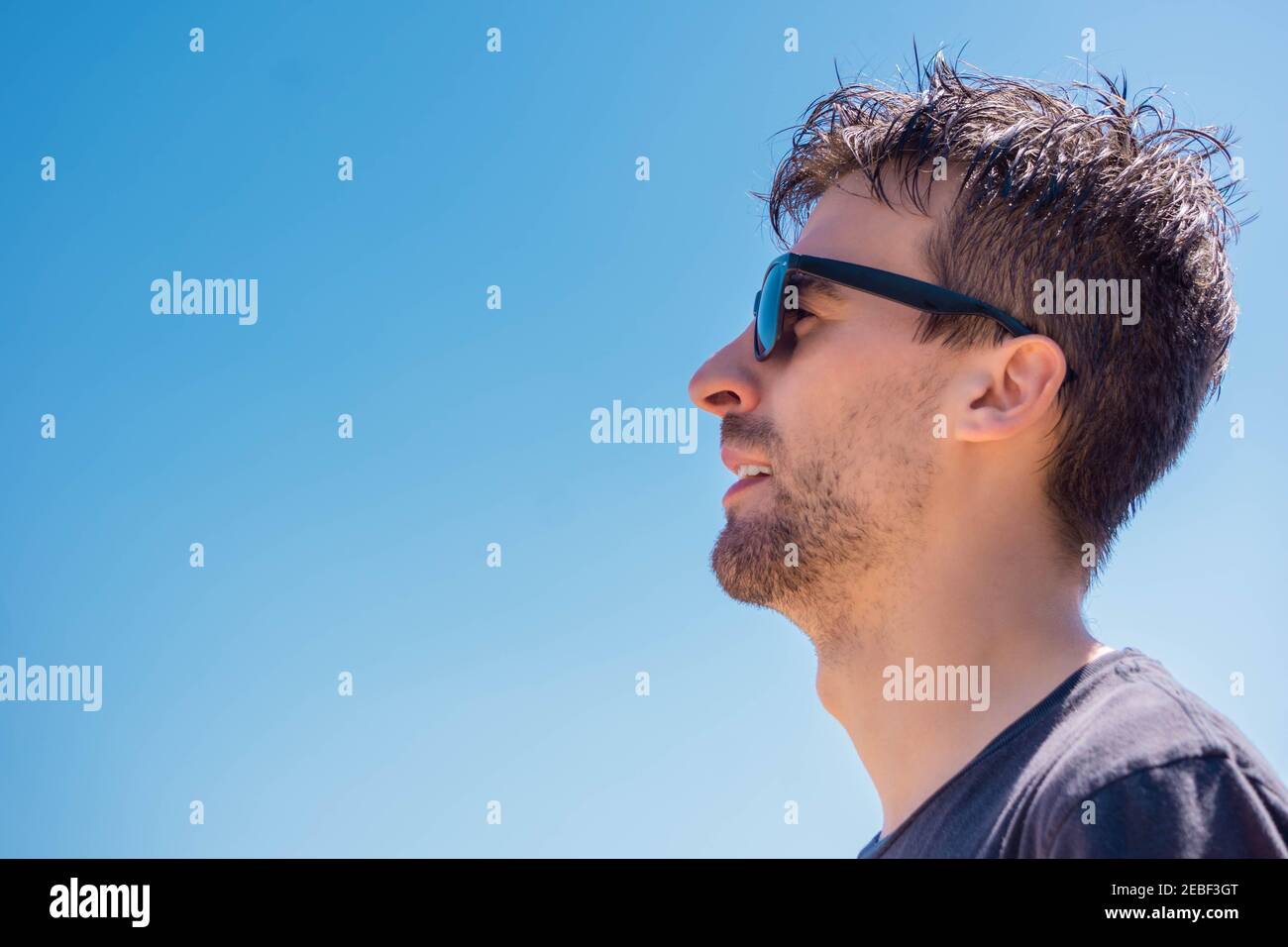 Portrait of man with sunglasses. Profile of male with glasses of sun.  Confident handsome guy in sunglasses on blue sky background. Stylish man in  blac Stock Photo - Alamy