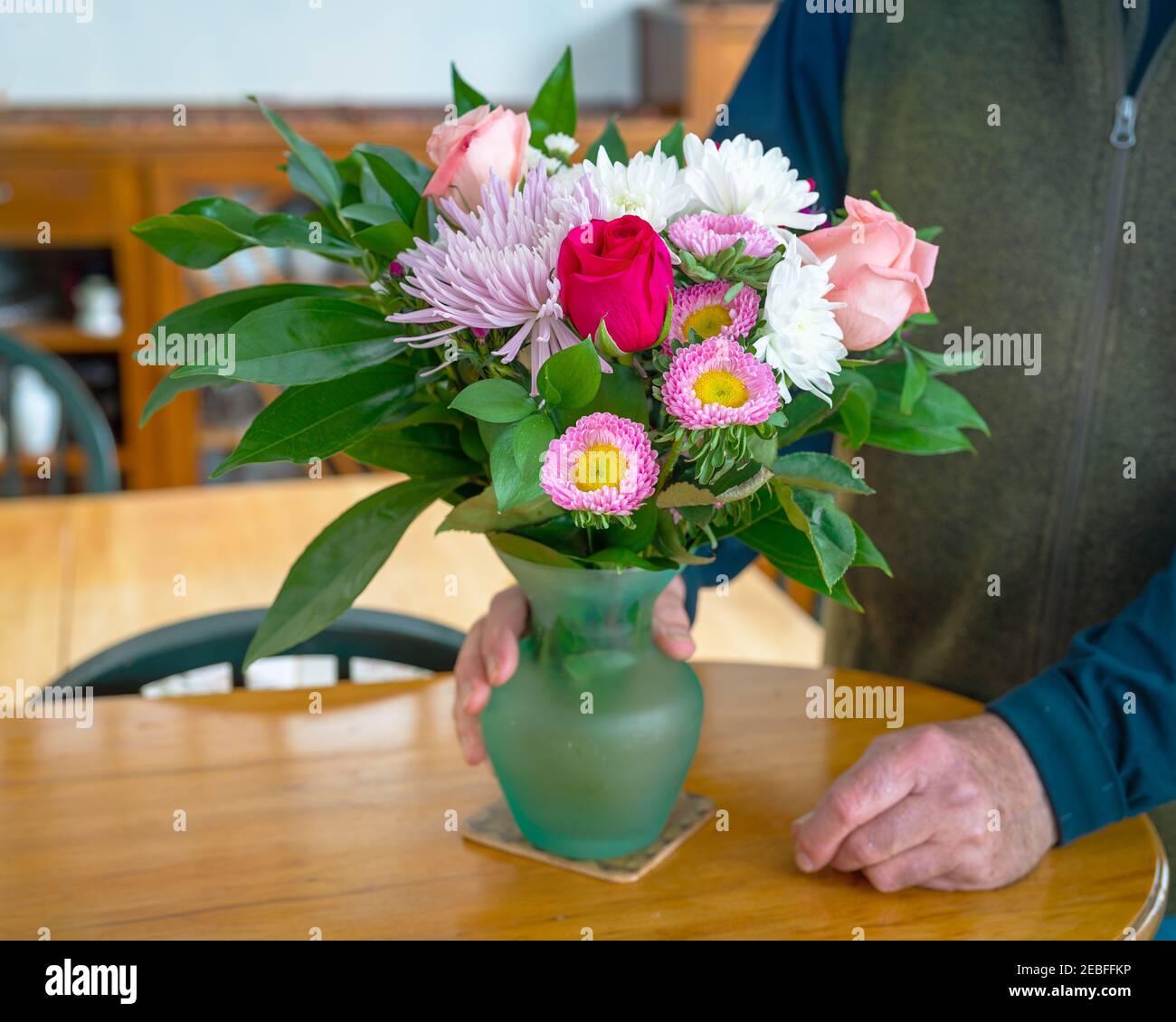 A bouquet of mixed flowers in a glass vase. Stock Photo