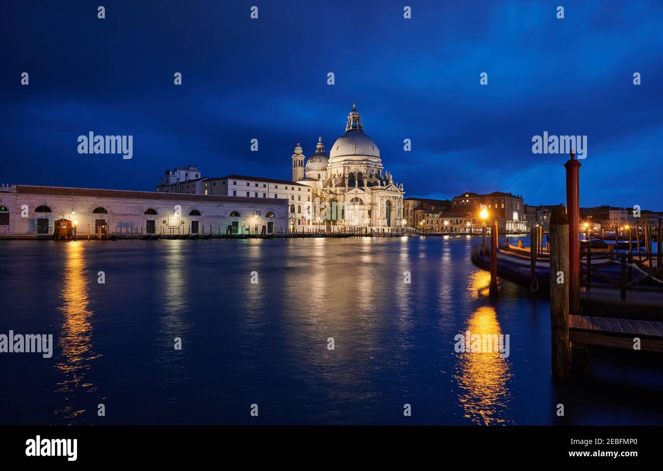 night shot of illuminated Basilica di Santa Maria della Salute with Punta della Dogana, Venice, Veneto, Italy Stock Photo