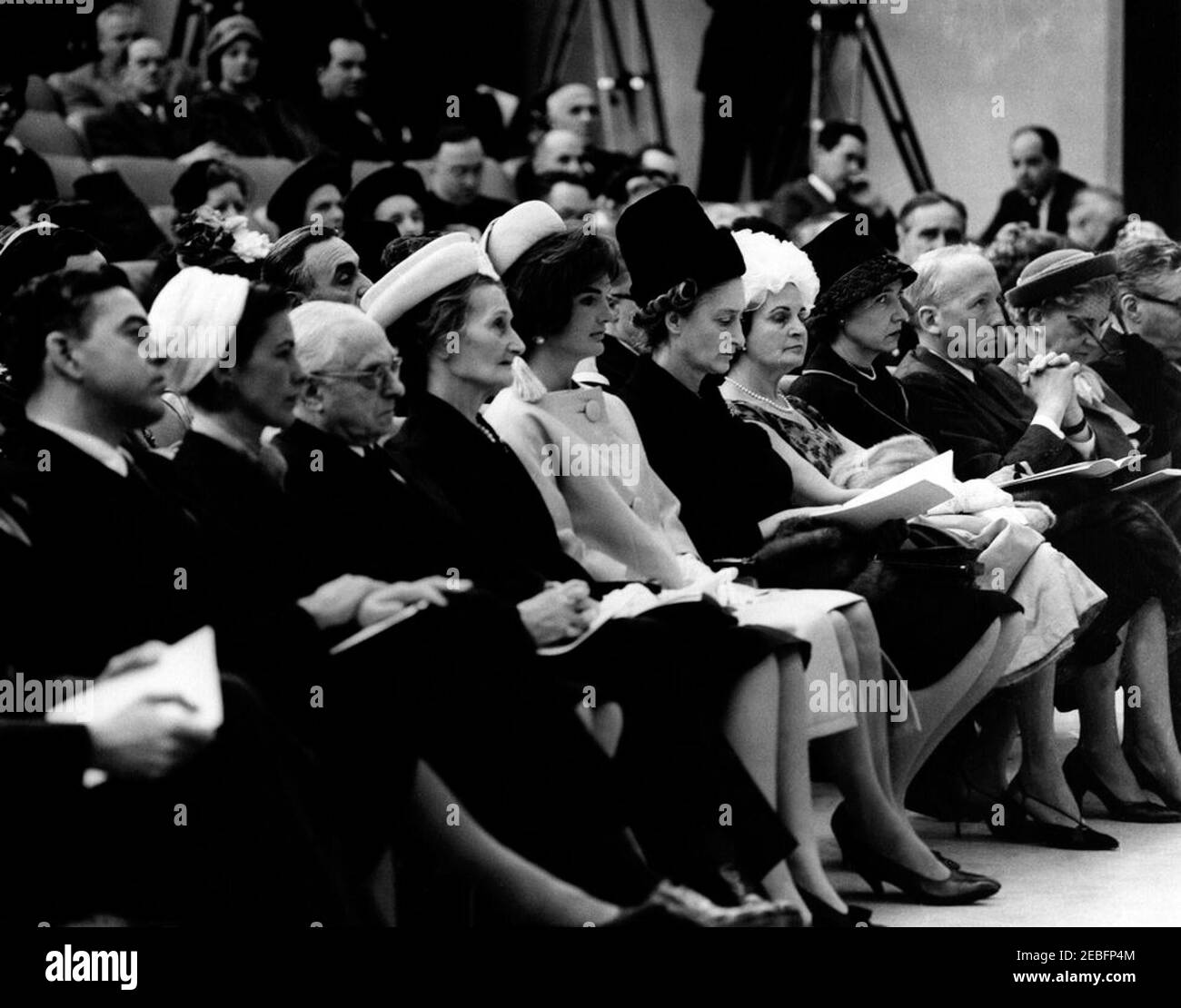 Ceremony celebrating the Unification of Italy, 10:31AM. Ceremony celebrating the Unification of Italy. First Lady Jacqueline Kennedy (center) sits in first row of audience; others unidentified. State Department Auditorium, Washington, D.C. Stock Photo
