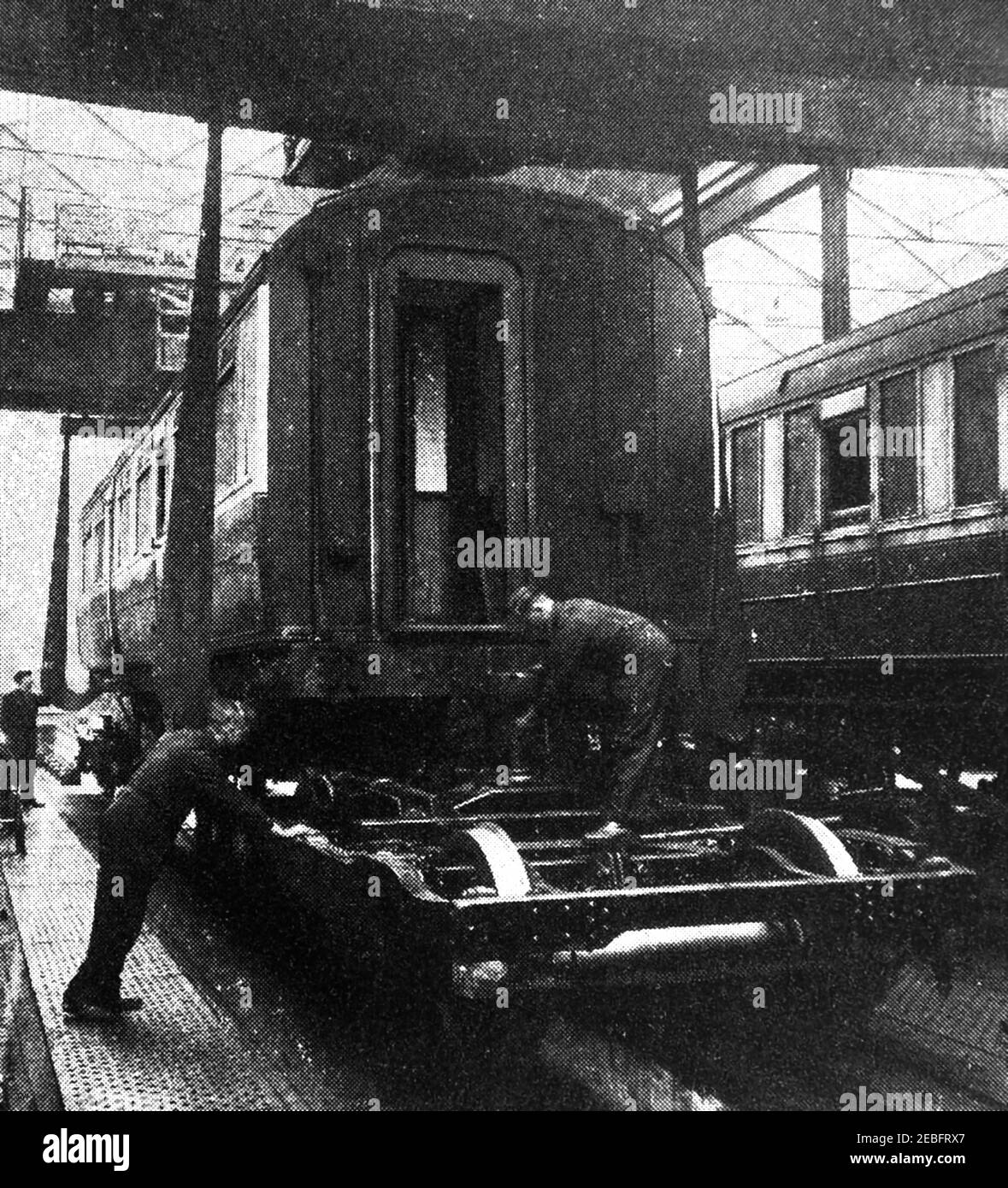 An early photograph of a carriage being lowered onto its wheels at the the Railway Locomotive carriage works at Doncaster, England. Doncaster railway works  located in the town of Doncaster, South Yorkshire, England. replaced an earlier works at Boston and Peterborough. Like other factories it was comandeered during WWII to make other items like  Horsa gliders for the D-Day  airborne assault. The carriage building shop was destroyed by ire in 1940, the new buildings built in 1949 were designed to fit  the British Railways standard all steel carriages. Steam train construction finished in 1962. Stock Photo