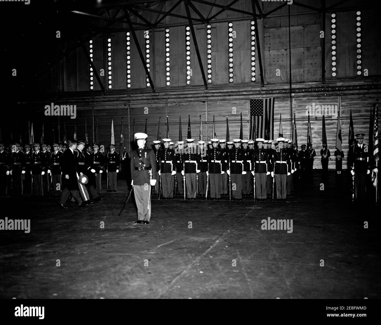 Arrival ceremonies for Kwame Nkrumah, President of Ghana, 3:43PM. President John F. Kennedy (walking at left) and President of the Republic of Ghana, Osagyefo Dr. Kwame Nkrumah, review U.S. Army Honor Guard and Marine Corps Honor Guard troops with Commander of Troops, Lieutenant Colonel Charles P. Murray, Jr., during arrival ceremonies in honor of President Nkrumah. Hangar #10, Military Air Transport Service (MATS) Terminal, Washington National Airport, Washington, D.C. Stock Photo
