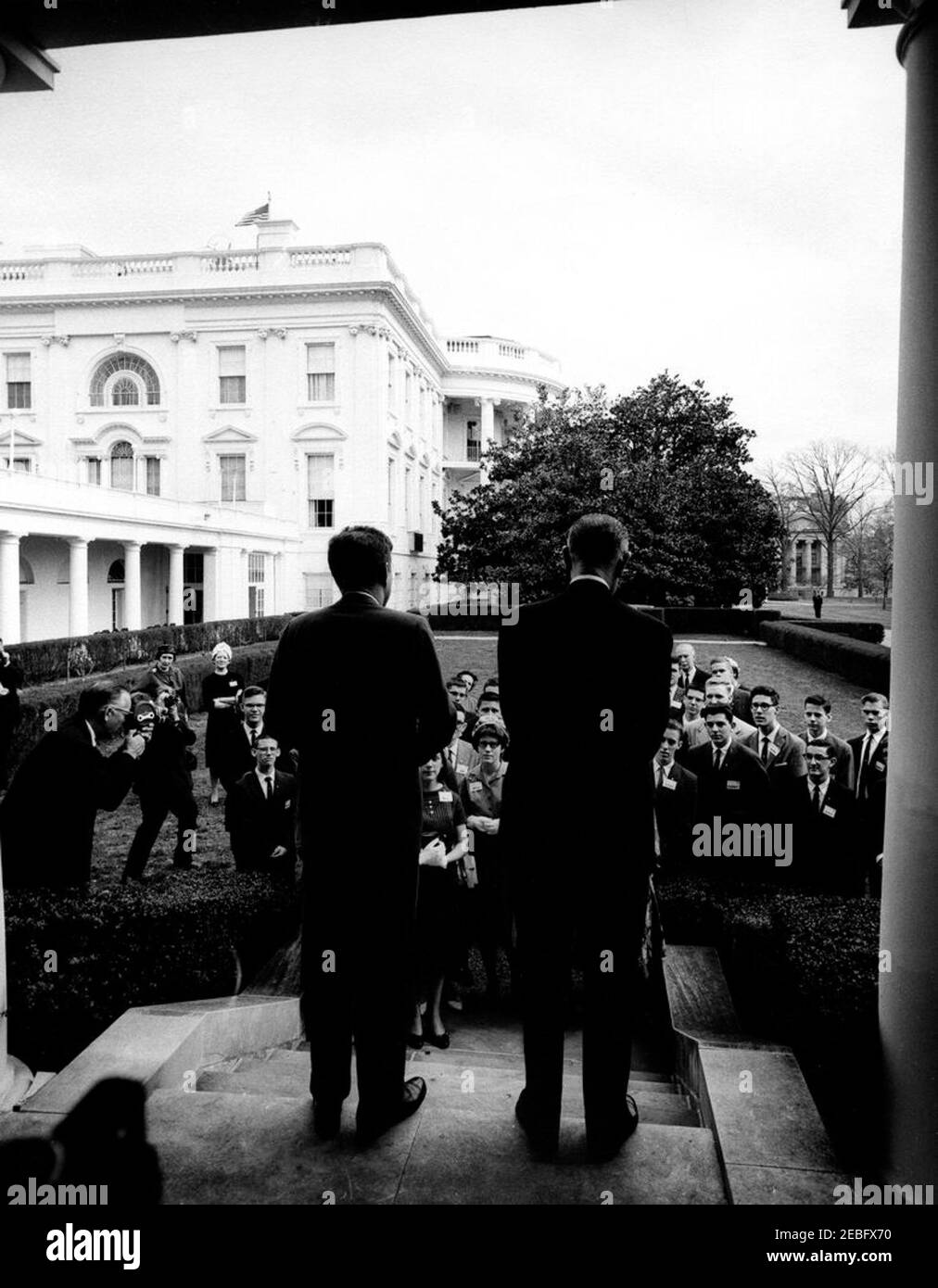 Visit of winners of the 20th Annual Science Talent Search, 12:05PM. Visit of the winners of the 20th Annual Westinghouse Science Talent Search (Science Service). President John F. Kennedy and Vice President Lyndon B. Johnson addressing visitors, with backs to camera. Left of President Kennedy: Donald Richard Hoffman (in front); unidentified boy; two unidentified women standing in back; two unidentified photographers standing at left. Between Kennedy and Johnson (front to back): Ann Mayer; Mary Sue Wilson; Michael Edward Lesk; others unidentified. Right of Johnson (L-R): James Michael Hosford; Stock Photo