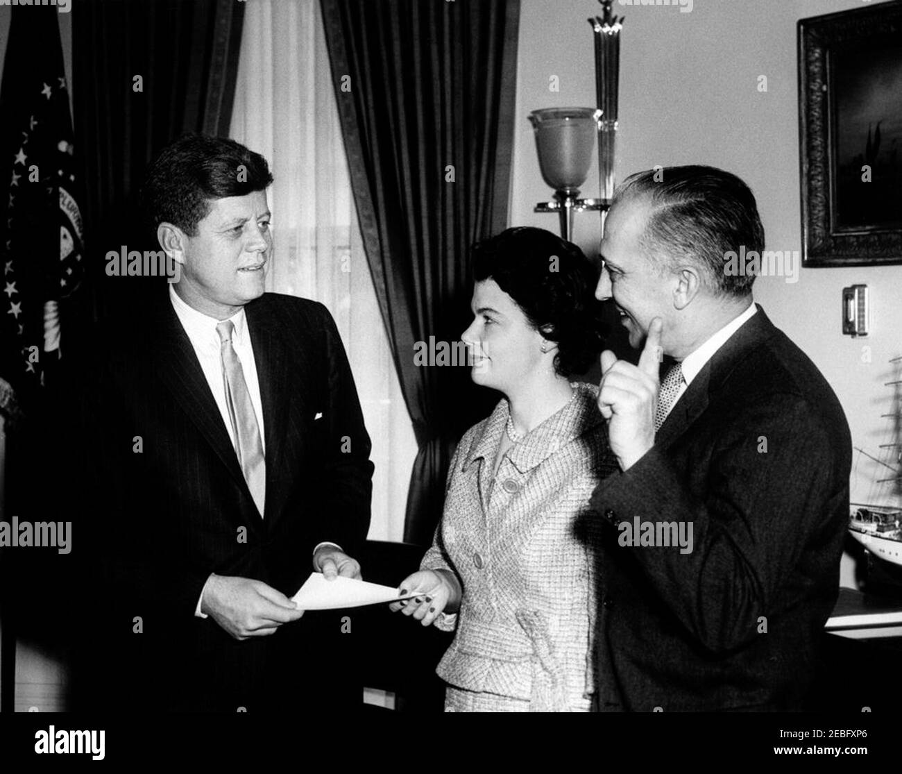 Visit of representatives of the National Symphony Orchestra (NSO) Fund Campaign, 12:20PM. Visit of representatives of the National Symphony Orchestra Fund Campaign. President John F. Kennedy speaks with National Symphony Orchestra representatives in connection with the Kick-Off of the 1961 Sustained Fund Campaign. President Kennedy; Campaign Publicity Director, Helen Dudman; Conductor Howard Mitchell. Oval Office, White House, Washington, D.C. Stock Photo