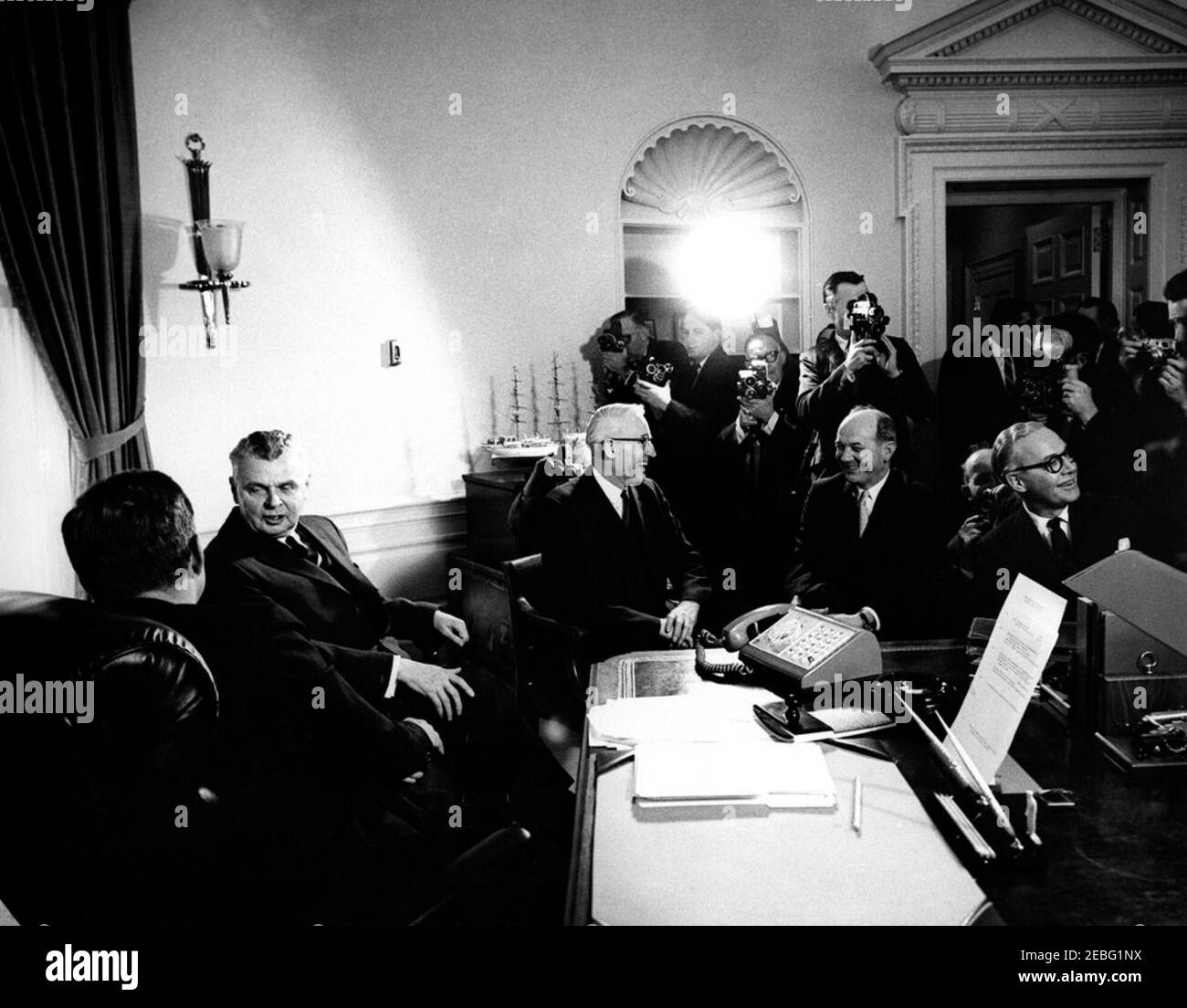 Meeting with John G. Diefenbaker, Prime Minister of Canada, 12:00PM. Photographers capture President John F. Kennedyu0027s meeting with Prime Minister John G. Diefenbaker of Canada in the Oval Office, White House, Washington, D.C. (L-R) President Kennedy; Prime Minister Diefenbaker; Secretary of State for External Affairs of Canada Howard C. Green; Secretary of State Dean Rusk; Canada Ambassador to the United States Arnold (A.D.P.) Heeney. Stock Photo