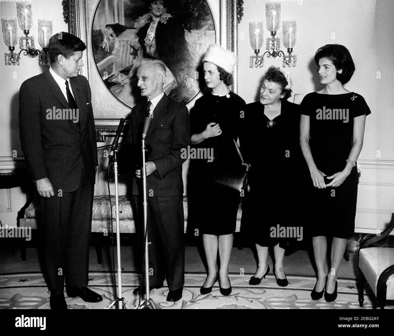 Presentation of an antique Irish silver christening cup for John F. Kennedy, Jr. (JFK, Jr.) to President Kennedy and First Lady Jacqueline Kennedy (JBK) by the Ambassador of Ireland, Thomas J. Kiernan, with wife Delia Murphy and Air Hostess Margaret Teresa Ryan. Presentation of silver Christening cup to President John F. Kennedy and First Lady Jacqueline Kennedy for John F. Kennedy, Jr. in Diplomatic Reception Room, White House, Washington, D.C. The two-hundred-year-old cup is from the Kennedy ancestral home in New Ross, County Wexford, Ireland. (L-R) President Kennedy; Irish Ambassador to the Stock Photo