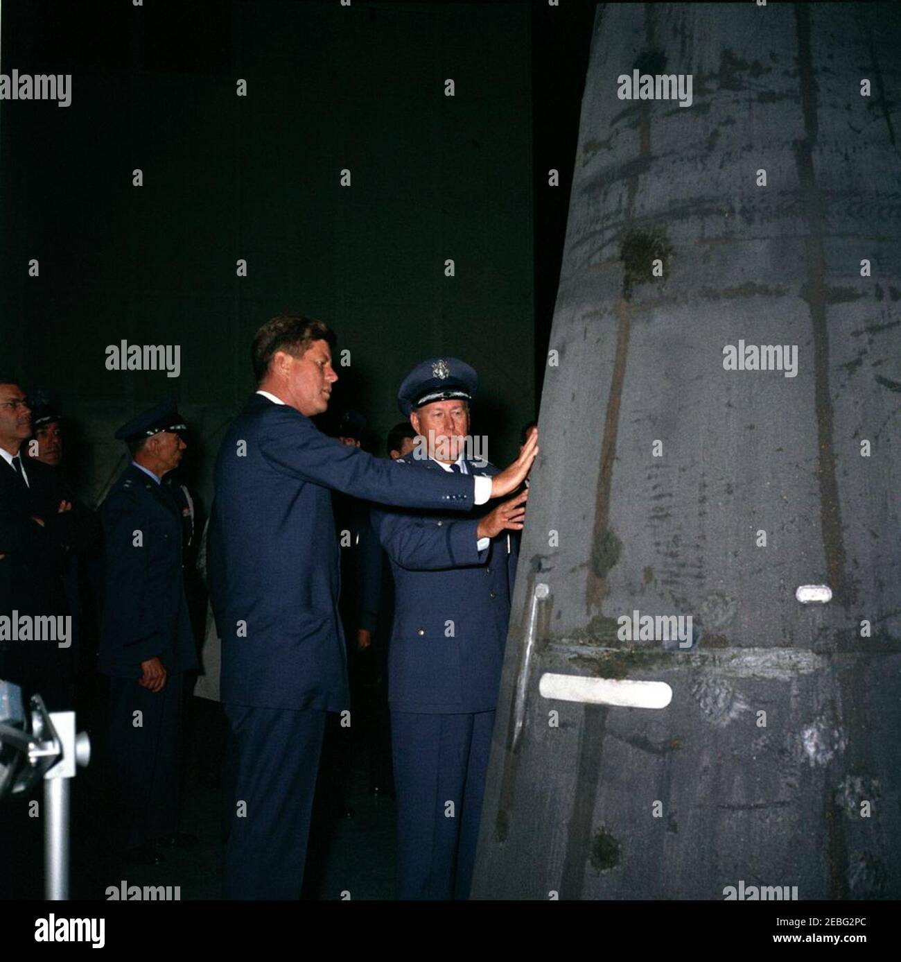 Trip to California: Vandenberg Air Force Base, 4:08PM. During a tour of space craft displays inside a hangar at Vandenberg Air Force Base in California, President John F. Kennedy views a recovered nose cone fired by an Atlas missile. Left to right: Secretary of Defense, Robert S. McNamara; Air Force Aide to the President, Brigadier General Godfrey T. McHugh; Major General Joseph J. Preston; President Kennedy; Commander of Strategic Air Command, General Thomas S. Power. Stock Photo