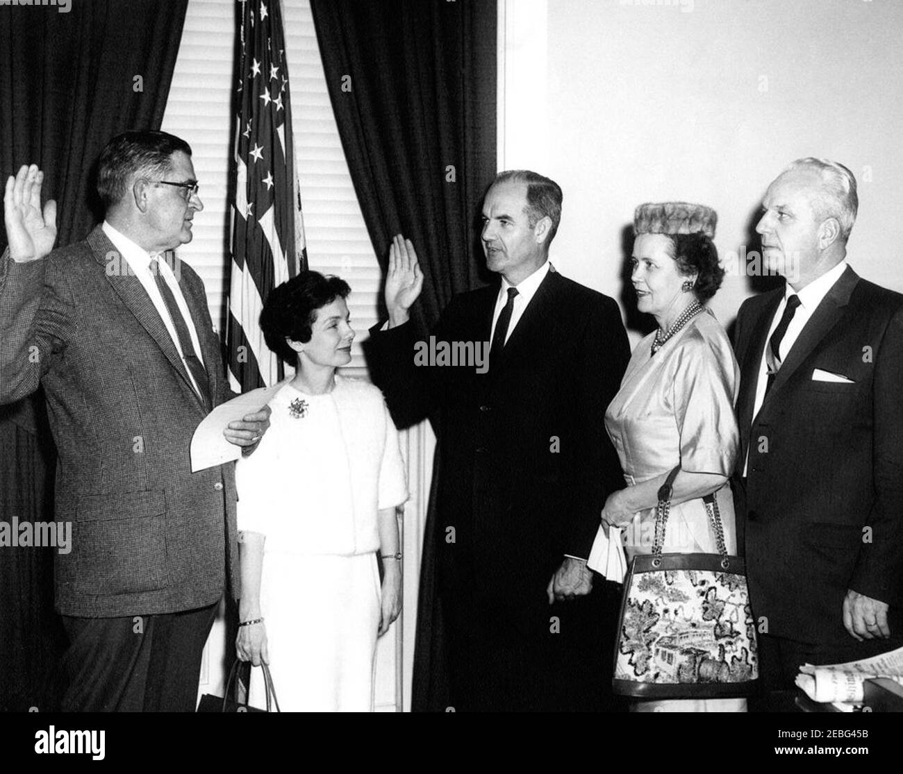 Swearing-in ceremony, George S. McGovern, Director, Food for Peace. Swearing in ceremony for George McGovern as Director of Food for Peace. (L-R) Assistant Executive Clerk of the White House Herbert L. Miller; Eleanor McGovern and husband George McGovern; Lorna Herseth and husband Ralph Herseth, former Governor of South Dakota. Executive Office Building, Washington, D.C.rnrn Stock Photo