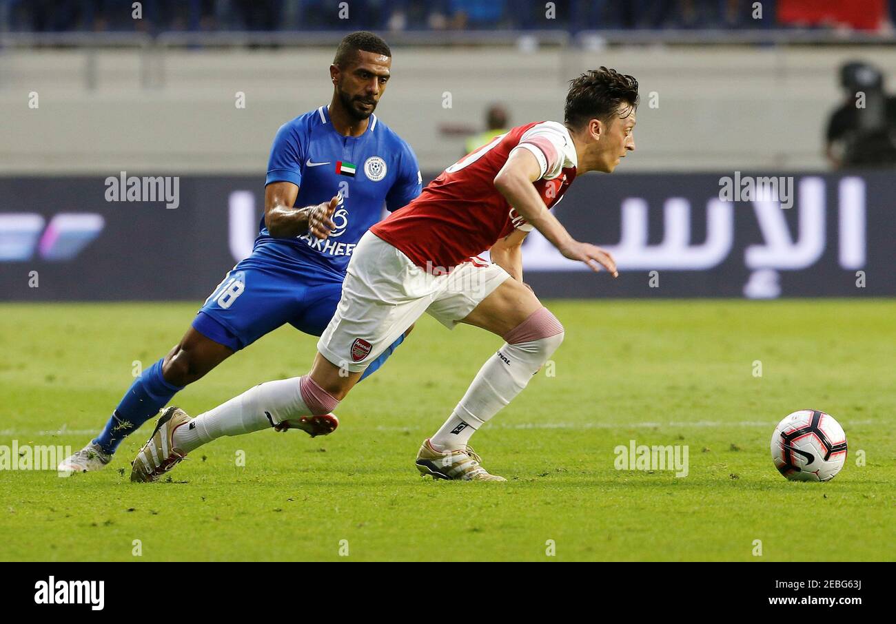 Soccer Football - Club Friendly Match - Al-Nasr SC v Arsenal - Al-Maktoum  Stadium, Dubai, United Arab Emirates - March 26, 2019 Arsenal's Mesut Ozil  in action with Al-Nasr's Ahmed Al Yassi