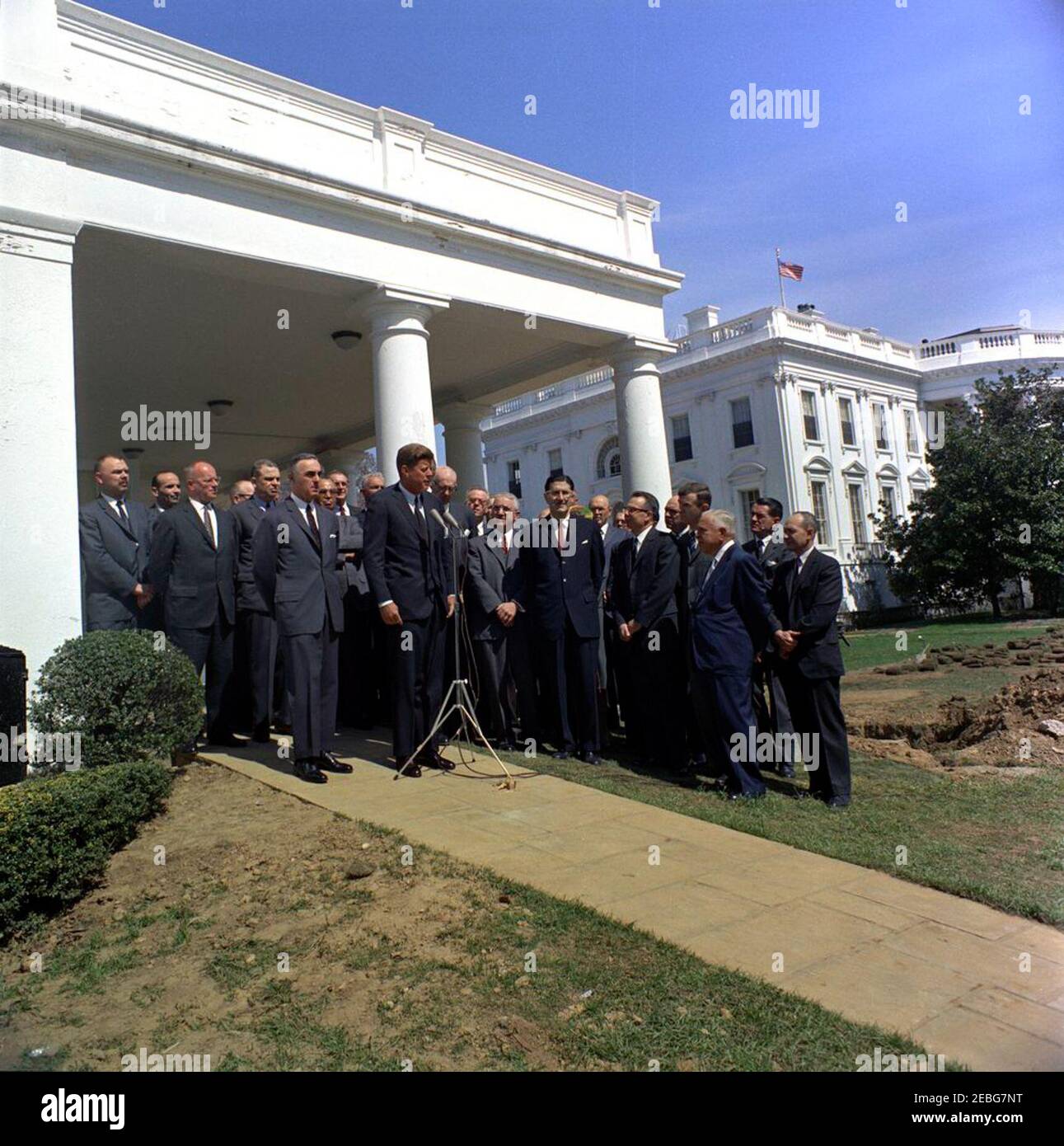 Meeting with doctors regarding medical care for the aged, 12:05PM. President John F. Kennedy (at microphones) speaks to the press during a meeting with doctors regarding medical care for the aged. Secretary of Health, Education, and Welfare Abraham Ribicoff stands left of President Kennedy. Doctors present include: Dr. Robert H. Alway, Dr. George Baehr, Dr. David Barr, Dr. Walter Bauer, Dr. Leona Baumgartner, Dr. E. Michael Bluestone, Dr. Katherine Boucot, Dr. Thomas Brem, Dr. DeWitt T. Burton, Dr. Martin Cherkasky, Dr. Robert E. Cooke, Dr. Edward P. Crump, Dr. Michael E. DeBakey, Dr. James P. Stock Photo