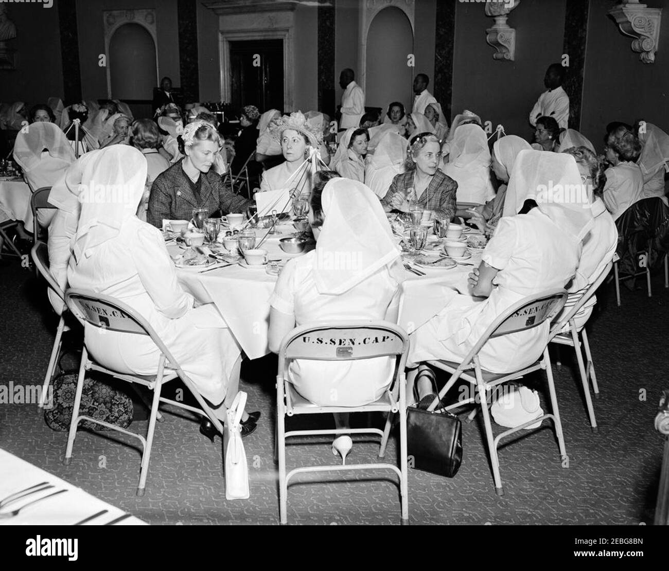 First Lady Jacqueline Kennedy (JBK) attends the Senate Ladiesu0027 Red Cross Unit Luncheon. Members of the Senate Ladies Red Cross Unit sit at a table during a luncheon (attended by First Lady Jacqueline Kennedy) in the Old Supreme Court Chamber, United States Capitol Building, Washington, D.C. The Red Cross unit (also known as u201cLadies of the Senateu201d) is comprised of the wives of members of the US Senate. Those seated at table in foreground include: Baroness Rosemary Silvercruys, former of wife Senator Brien McMahon (Connecticut); Estelle Cadorette McGrath, wife of former Senator J. Stock Photo