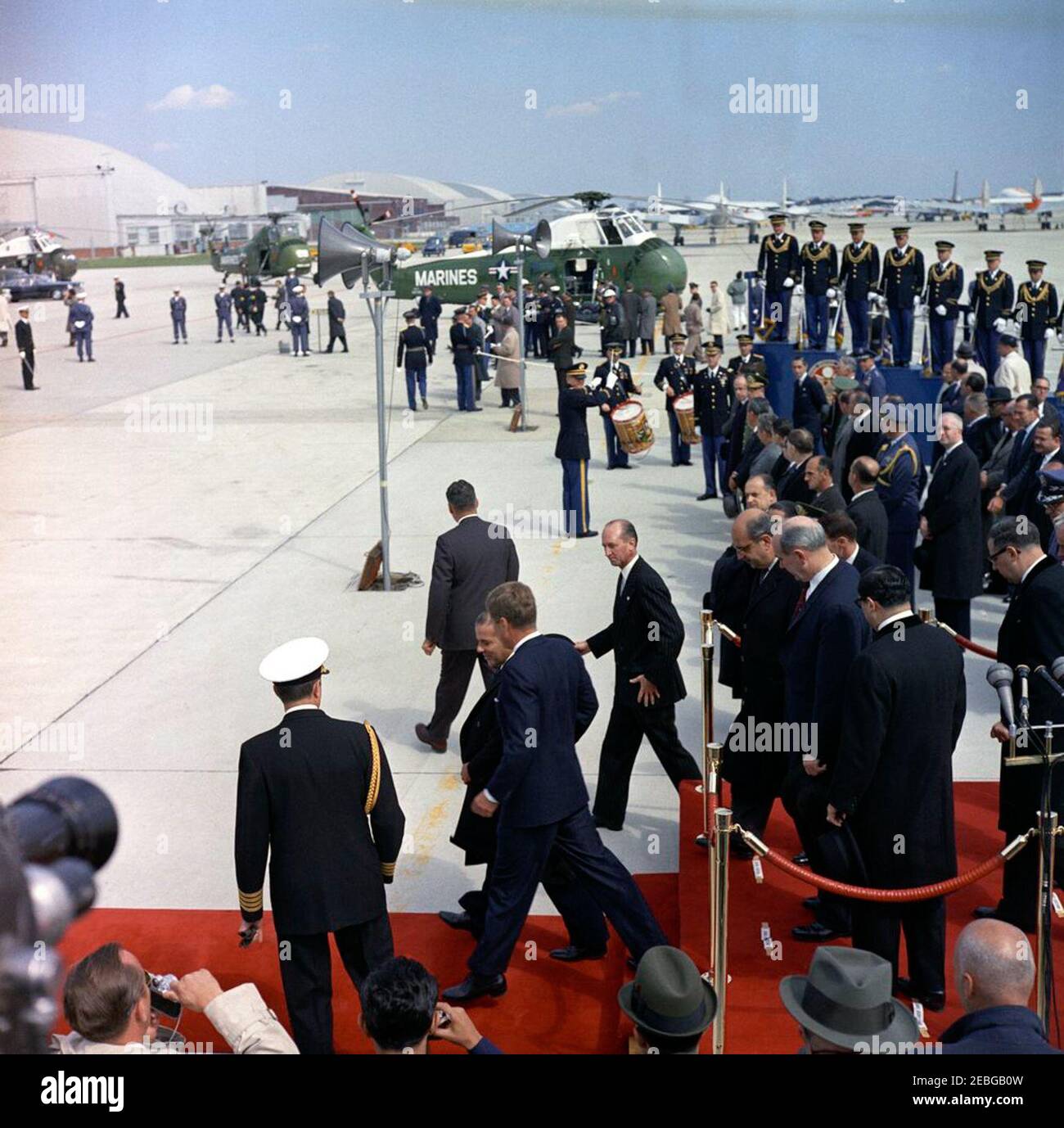 Arrival ceremony for Jou00e3o Goulart, President of Brazil, 10:00AM. President John F. Kennedy and President of Brazil Jou00e3o Goulart leave the reviewing platform during arrival ceremonies for President Goulart at Andrews Air Force Base, Maryland. Walking in front of the platform (L-R): Naval Aide to the President Captain Tazewell Shepard, Jr. (back to camera), President Kennedy, President Goulart, White House Secret Service agent Gerald A. u201cJerryu201d Behn (back to camera), and Chief of Protocol Angier Biddle Duke (in back). Standing on the platform (L-R): Brazilian Minister of Fore Stock Photo