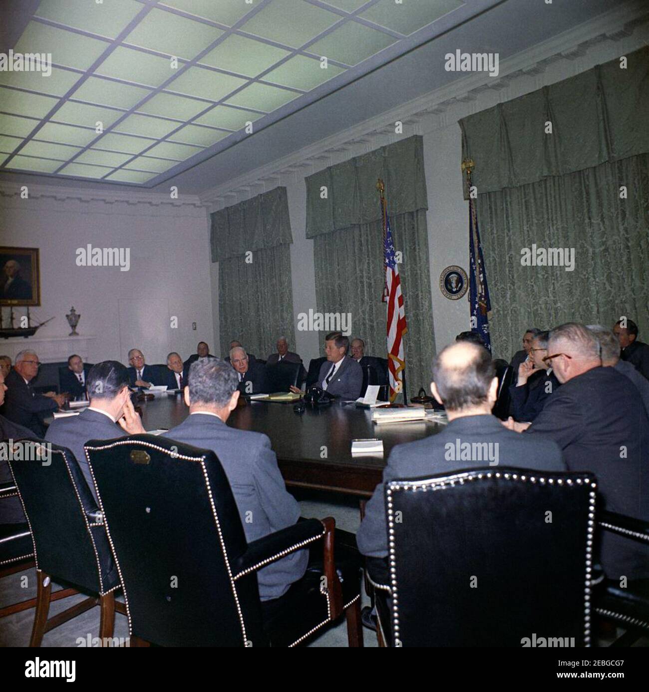 Visit of members of the National Export Expansion Council in the Cabinet Room, 12:10PM. President John F. Kennedy (center, seated at right side of table) talks with members of the National Export Expansion Council in the Cabinet Room of the White House, Washington, D.C. Secretary of Commerce Luther H. Hodges sits left of President Kennedy; Roger P. Sonnabend, Executive Vice President of Hotel Corporation of America (three seats left of Secretary Hodges), sits at the head of the table; all others are unidentified. [Please see the Presidentu2019s schedule for a complete list of attendees.] Stock Photo