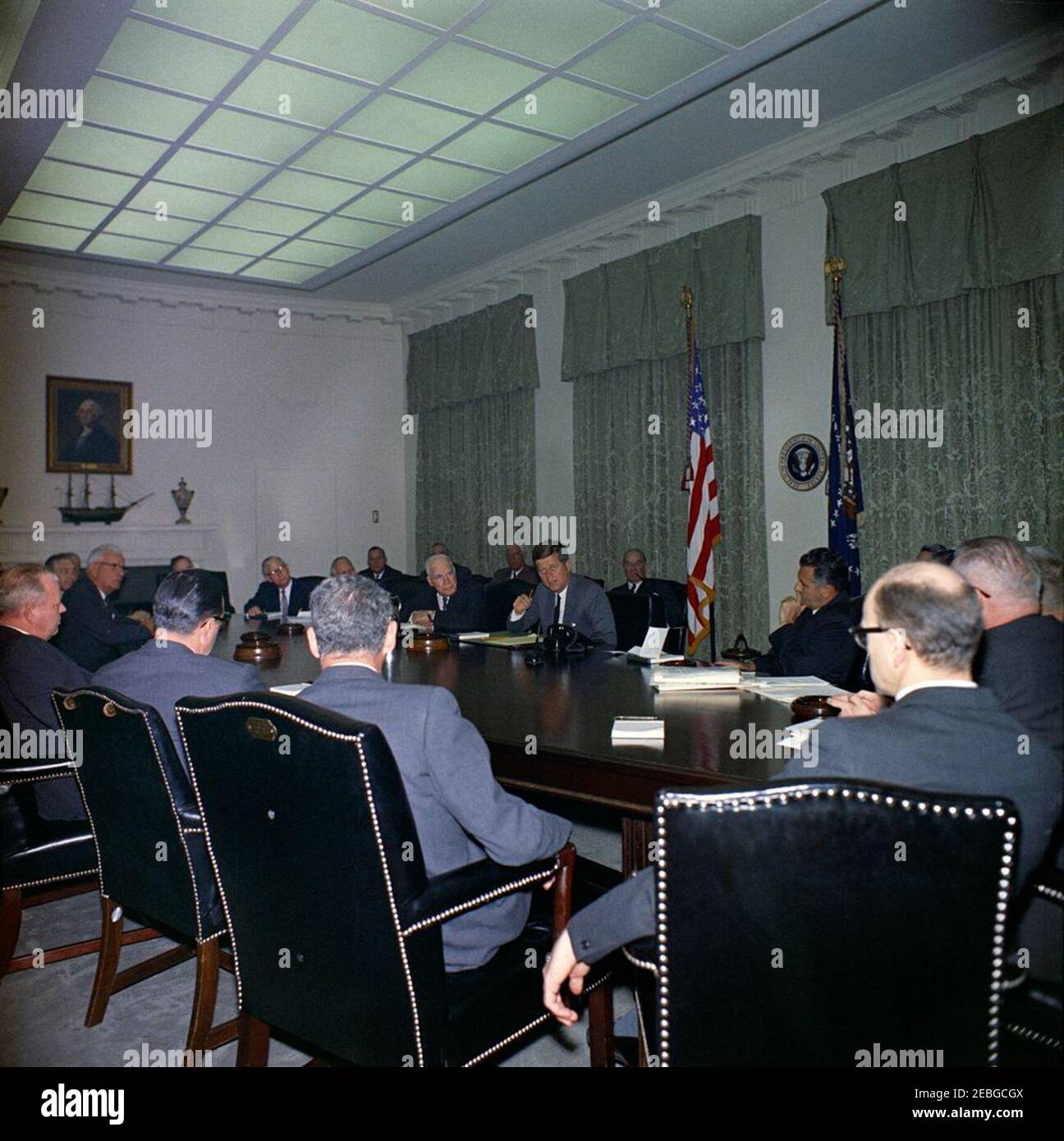 Visit of members of the National Export Expansion Council in the Cabinet Room, 12:10PM. President John F. Kennedy (center, seated at right side of table) talks with members of the National Export Expansion Council in the Cabinet Room of the White House, Washington, D.C. Secretary of Commerce Luther H. Hodges sits left of President Kennedy; Roger P. Sonnabend, Executive Vice President of Hotel Corporation of America (three seats left of Secretary Hodges, mostly hidden), sits at the head of the table; all others are unidentified. [Please see the Presidentu2019s schedule for a complete list of a Stock Photo