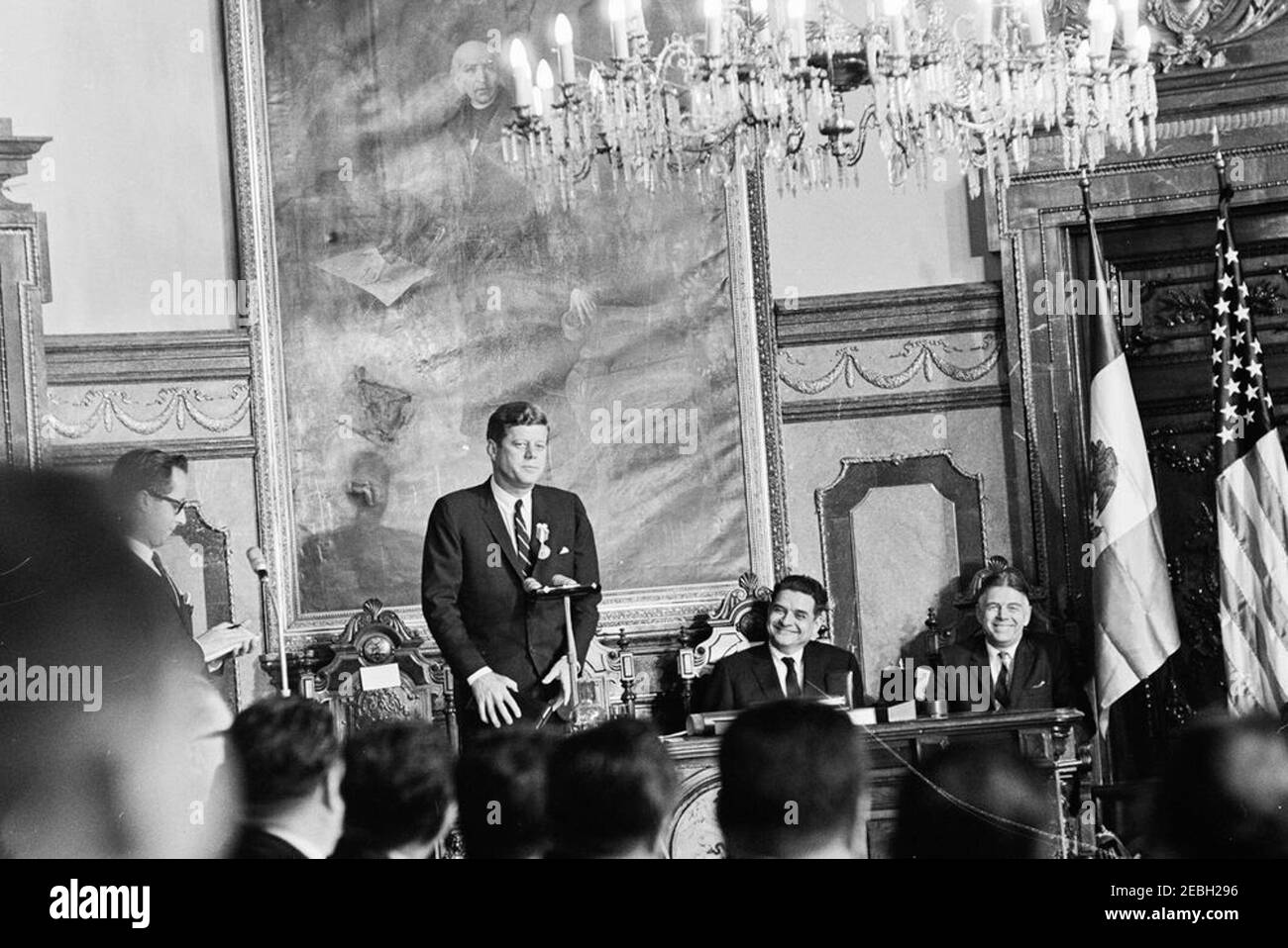 Trip to Mexico: Ceremony at City Hall, 5:05PM. President John F. Kennedy delivers remarks at a ceremony in honor of his visit to Mexico City. Governor of the Federal District, Ernesto P. Uruchurtu, presented President Kennedy with keys to the City of Mexico, a commemorative medal, and a scroll during the ceremony. Pictured at desk (L-R): U.S. State Department interpreter, Donald Barnes (mostly hidden); President Kennedy; Mr. Uruchurtu; U.S. Assistant Secretary of State for Inter-American Affairs, Edwin M. Martin. Salu00f3n de Cabildos (Council Room), Antiguo Palacio del Ayuntamiento (Old City Stock Photo