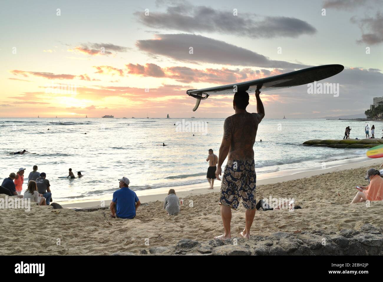 People watching spectacular sunset on the Waikiki Beach, native Hawaii