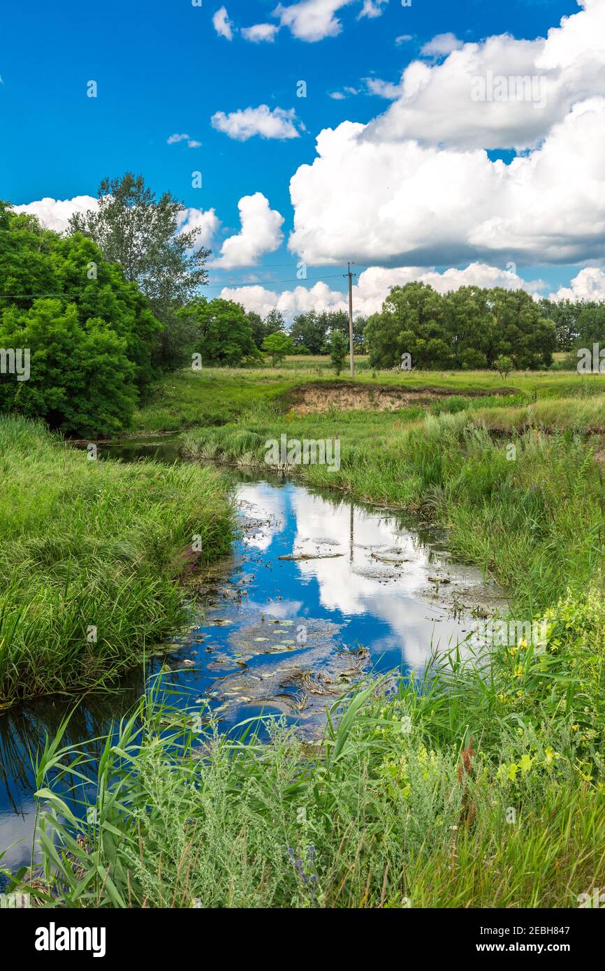 Summer landscape with river and cloudy sky Stock Photo - Alamy