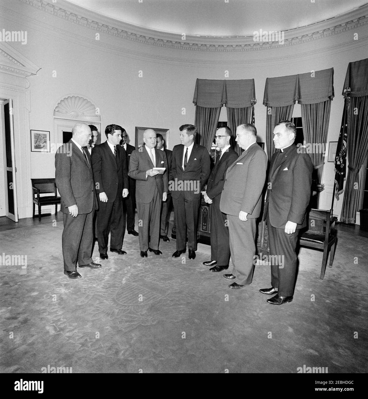 Meeting with the US Commission on Civil Rights, 5:10PM. Robert G. Storey, Vice Chairman of the United States Commission on Civil Rights and President of the Southwestern Legal Center, presents President John F. Kennedy (center) with a bound volume of the U.S. Commission on Civil Rightsu0027 report, u0022Freedom to the Free,u0022 during a meeting in the Oval Office of the White House, Washington, D.C. The report was autographed by officers and members of the Commission. Left to right: Robert S. Rankin, Chairman of the Political Science Department at Duke University; William L. Taylor, Commis Stock Photo